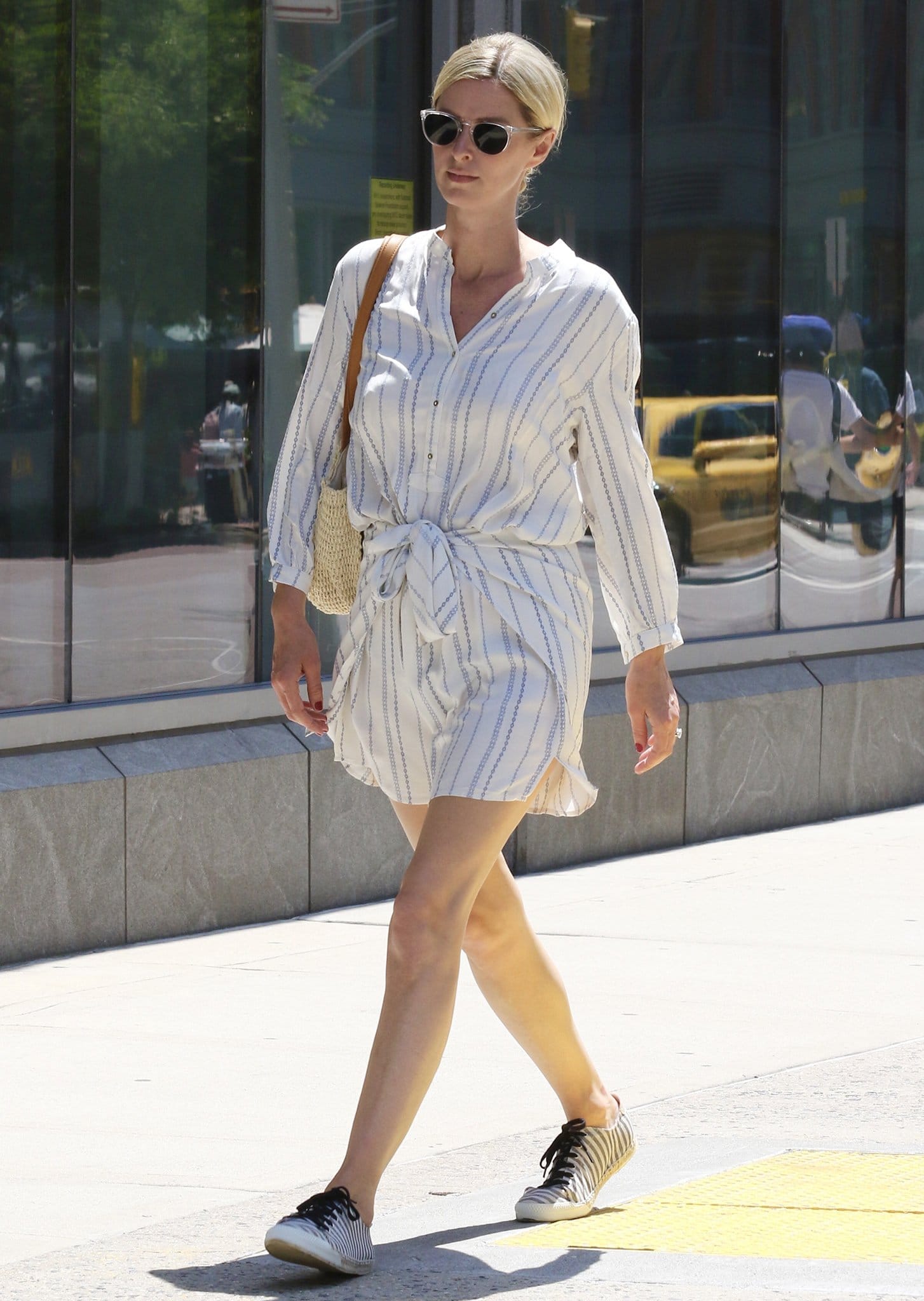 Nicky Hilton steps out in New York City on June 10, 2021, running errands in a breezy white striped romper styled with low-profile espadrille sneakers for effortless summer city dressing