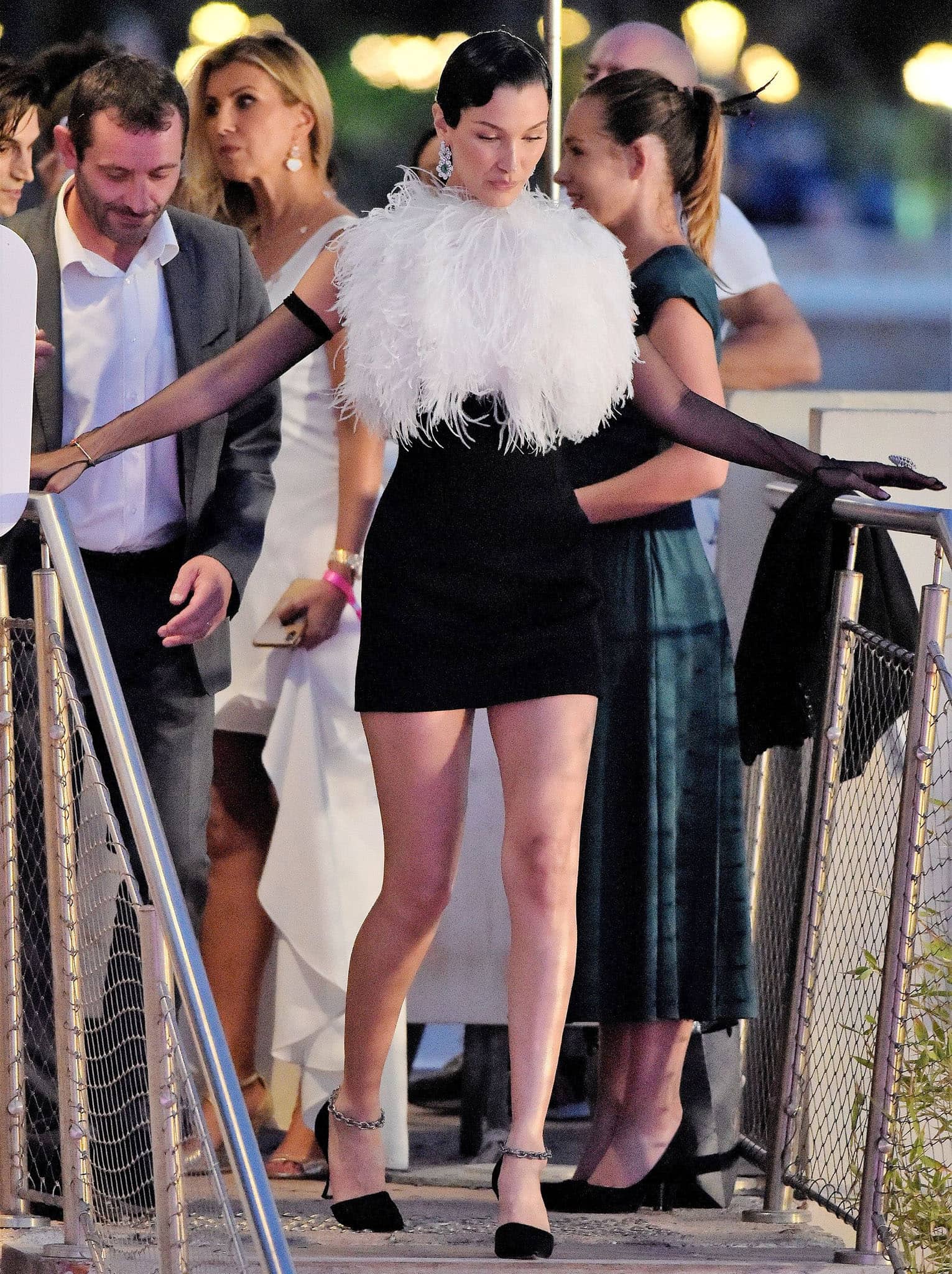 Bella pairs her feathered Lanvin mini dress with elegant black Manolo Blahnik Anclara pumps, their crystal ankle straps adding just the right touch of evening sparkle