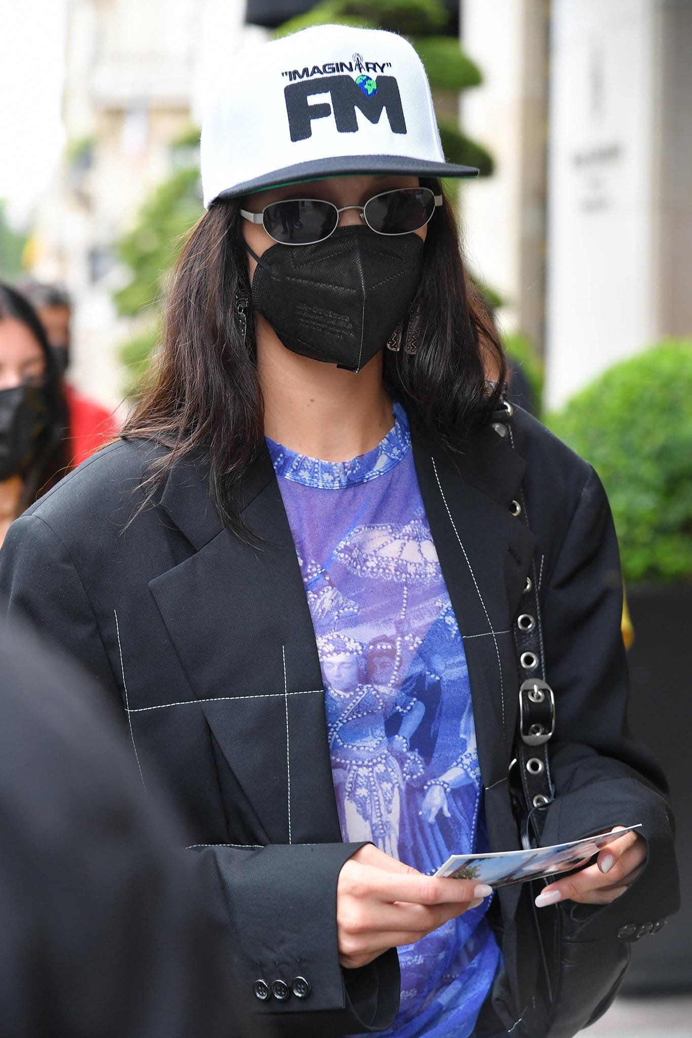 Bella Hadid jazzes up her edgy ensemble with a white Imaginary FM cap