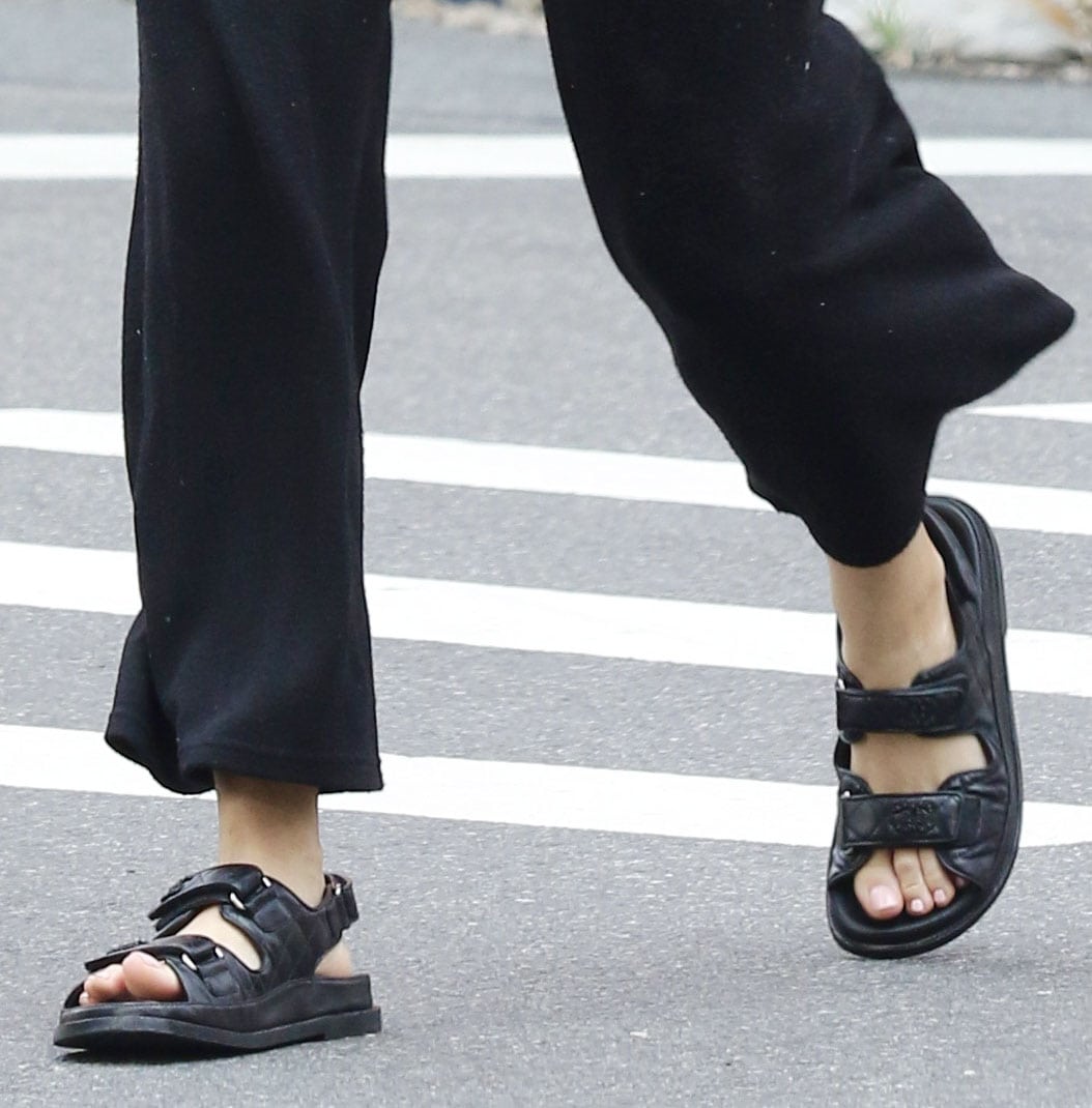 Blake Lively finishes her relaxed street-style look with Chanel’s black quilted dad sandals, featuring double Velcro straps, embossed CC logos, and a chunky molded sole