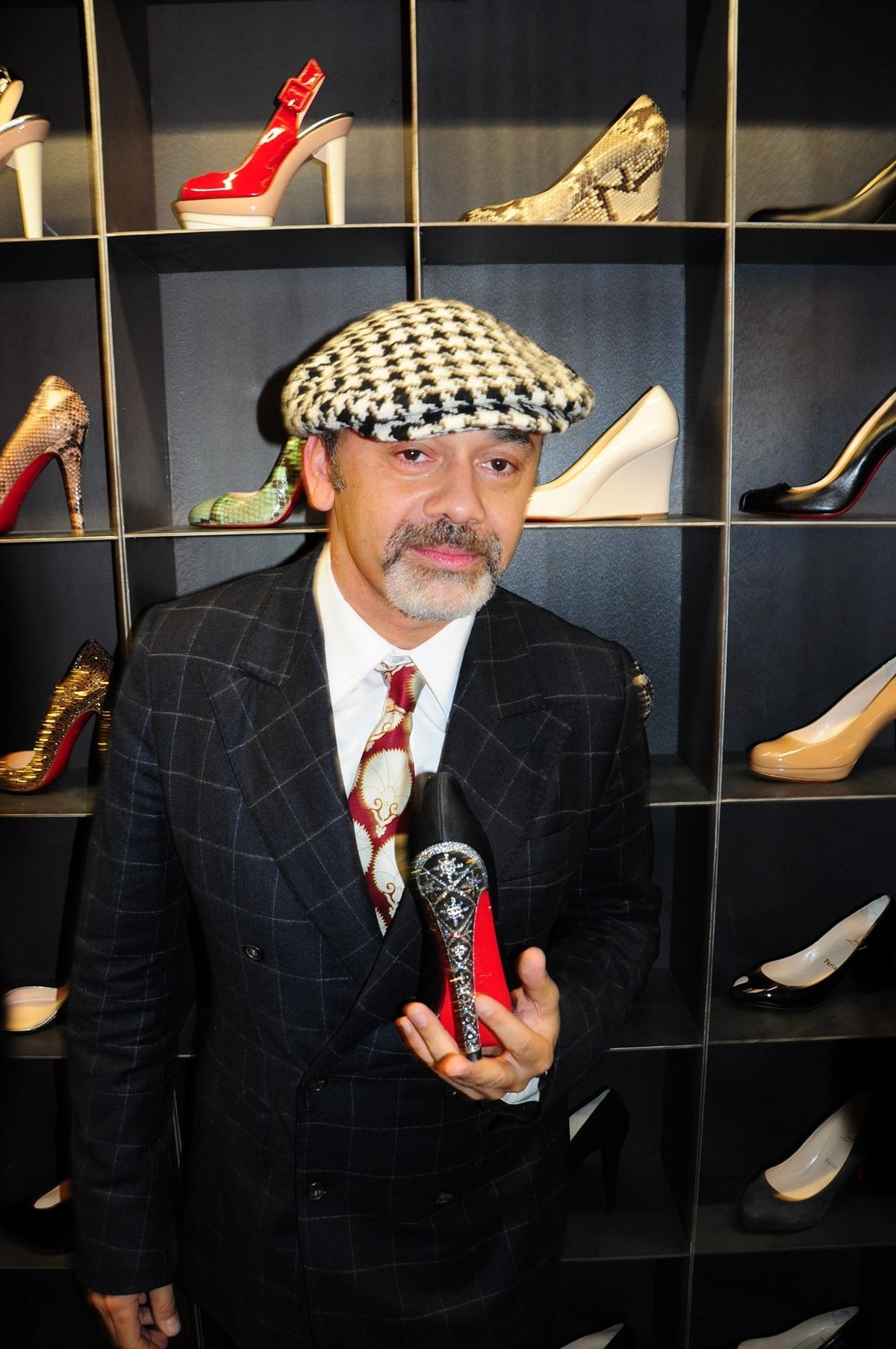 Christian Louboutin, the renowned French-Egyptian designer, is celebrated for his iconic red-soled shoes that blend Parisian elegance with a touch of exotic flair