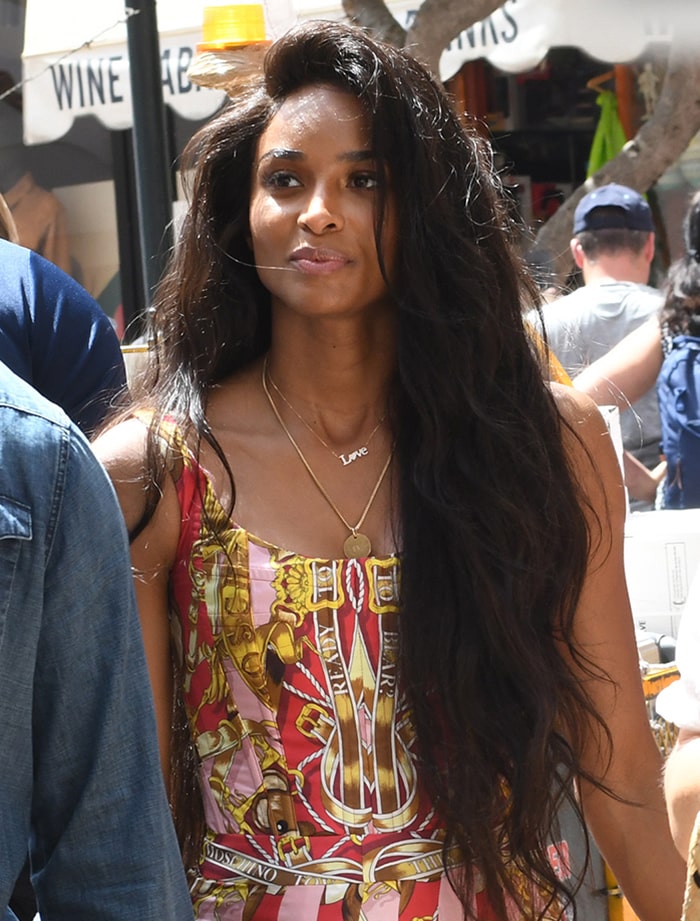A closer look highlights Ciara’s flowing waves, layered gold jewelry, and the intricate baroque-inspired print of her sleeveless mini dress