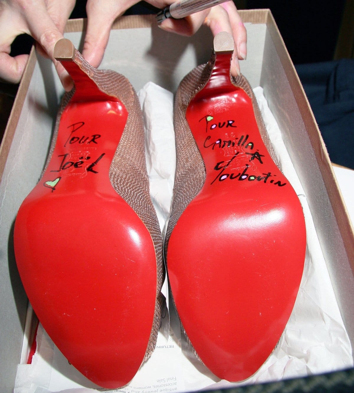 A pair of classic red-soled Christian Louboutins, personally signed by the designer, transforms into a one-of-a-kind collector’s treasure