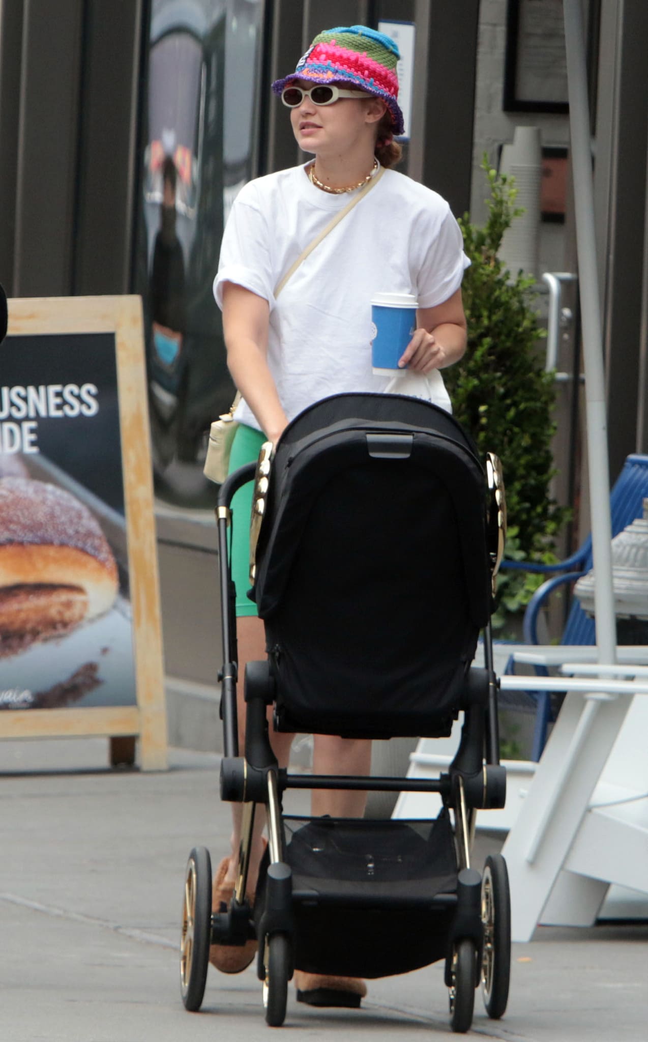 A colorful Etro crochet bucket hat and plush lettered mules bring personality to Gigi Hadid's otherwise minimalist summer street-style look