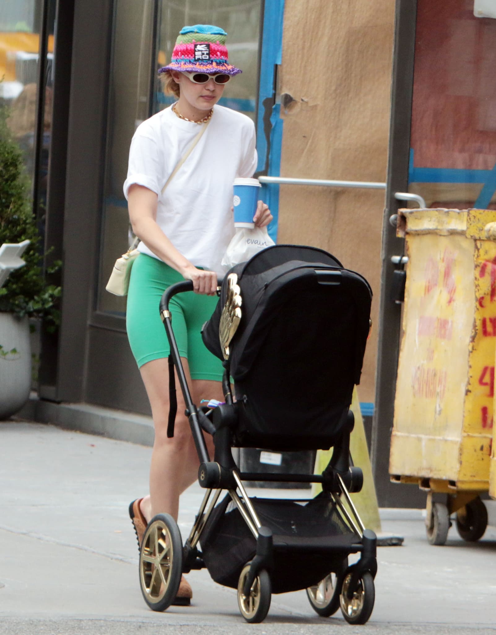 Even the stroller reflected the designer-minded approach seen throughout the outfit. Hadid pushed a limited-edition Cybex by Jeremy Scott Wings Priam stroller, a fashion-world favorite recognizable for its distinctive gold wing detailing