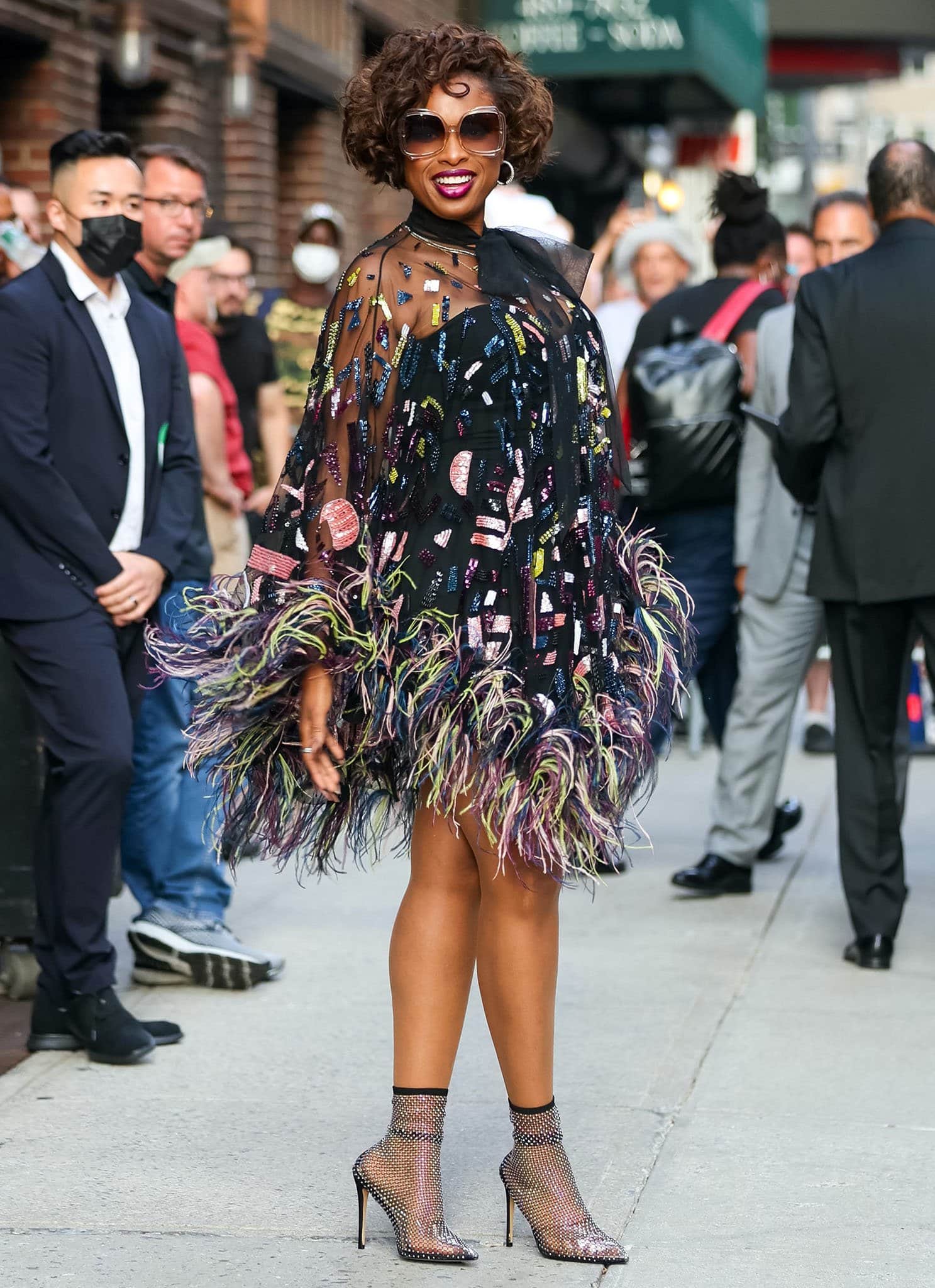Jennifer Hudson turns heads outside The Late Show with Stephen Colbert in a dazzling feather-trimmed Zuhair Murad mini dress, paired with crystal-embellished mesh booties and oversized sunglasses