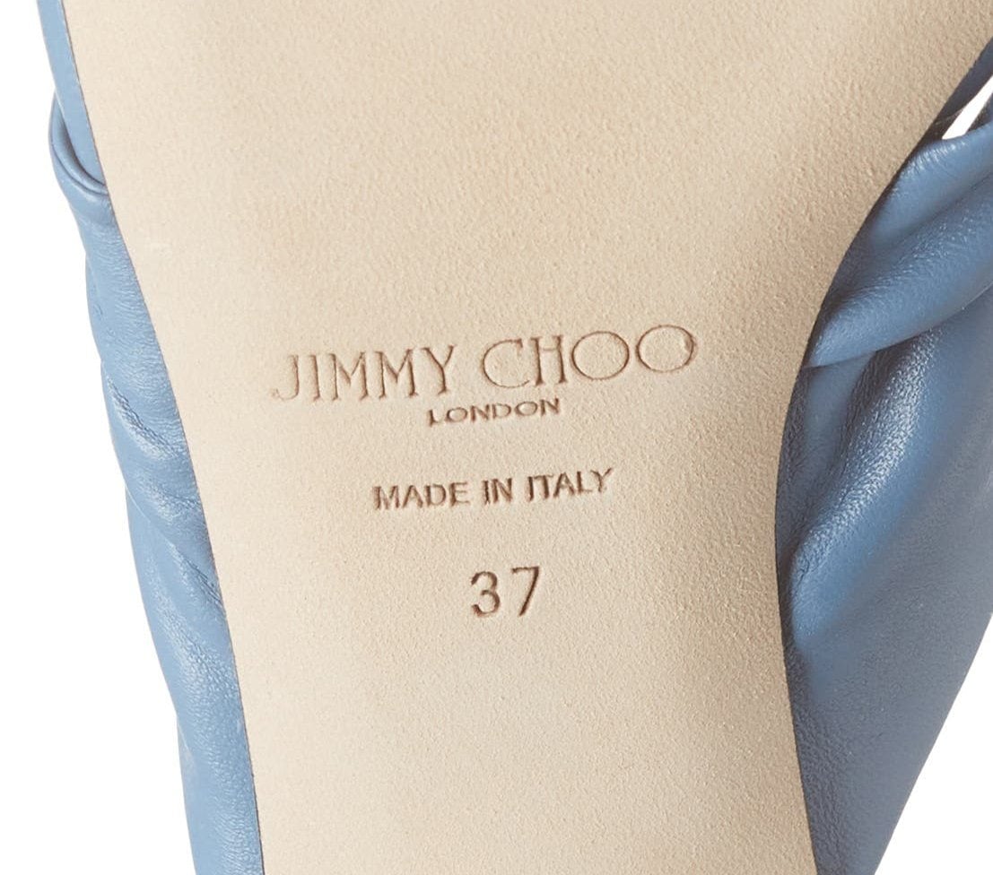 Jimmy Choo shoes feature the signature 'London' logo along with the 'Made in Italy' stamp, symbolizing the brand's commitment to quality and craftsmanship