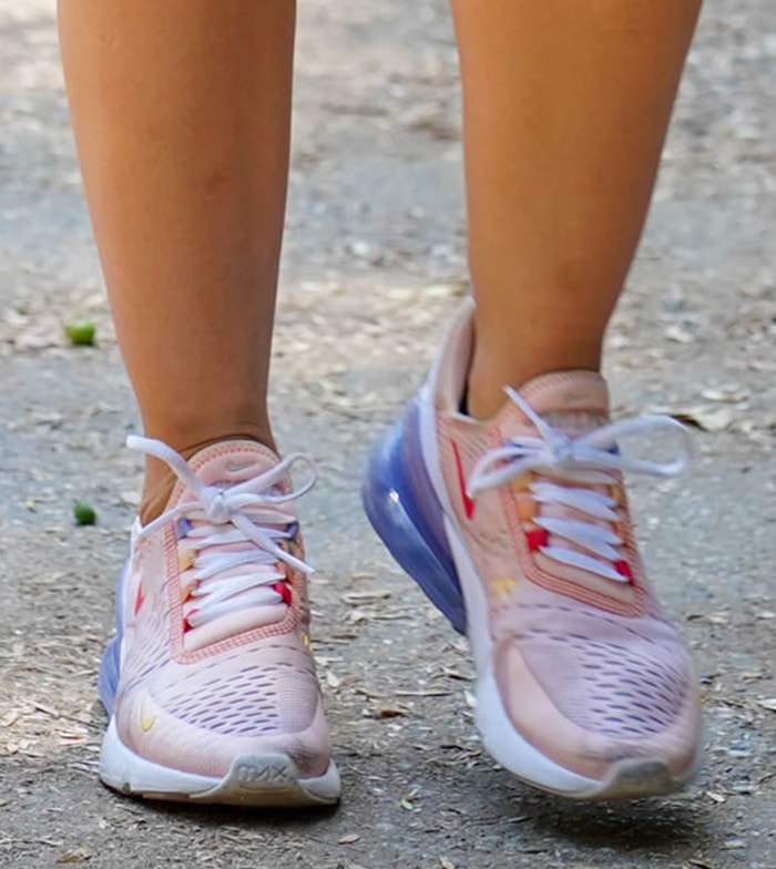 Lucy Hale's Spring 2020 Nike Air Max 270 React sneakers feature pastel pink mesh, vibrant multicolored accents, iridescent detailing, and the signature oversized 270-degree Max Air heel that defined one of Nike's most recognizable lifestyle silhouettes