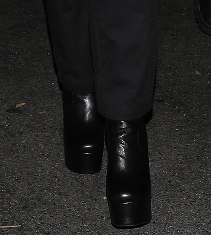 Nicola Peltz completes her all-black look with Saint Laurent Billy platform boots