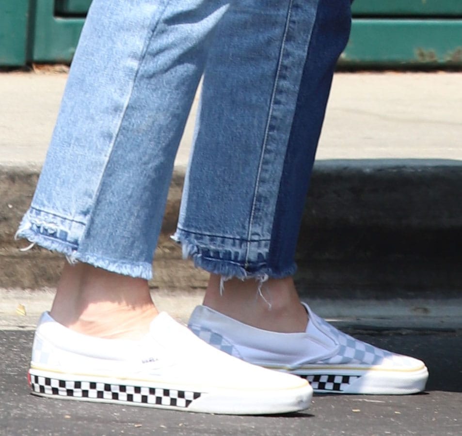 Gwen Stefani finishes her Canadian tuxedo with Vans Slip-On SF checkerboard sneakers, featuring a collapsible mule-style heel and checkerboard-wrapped midsole