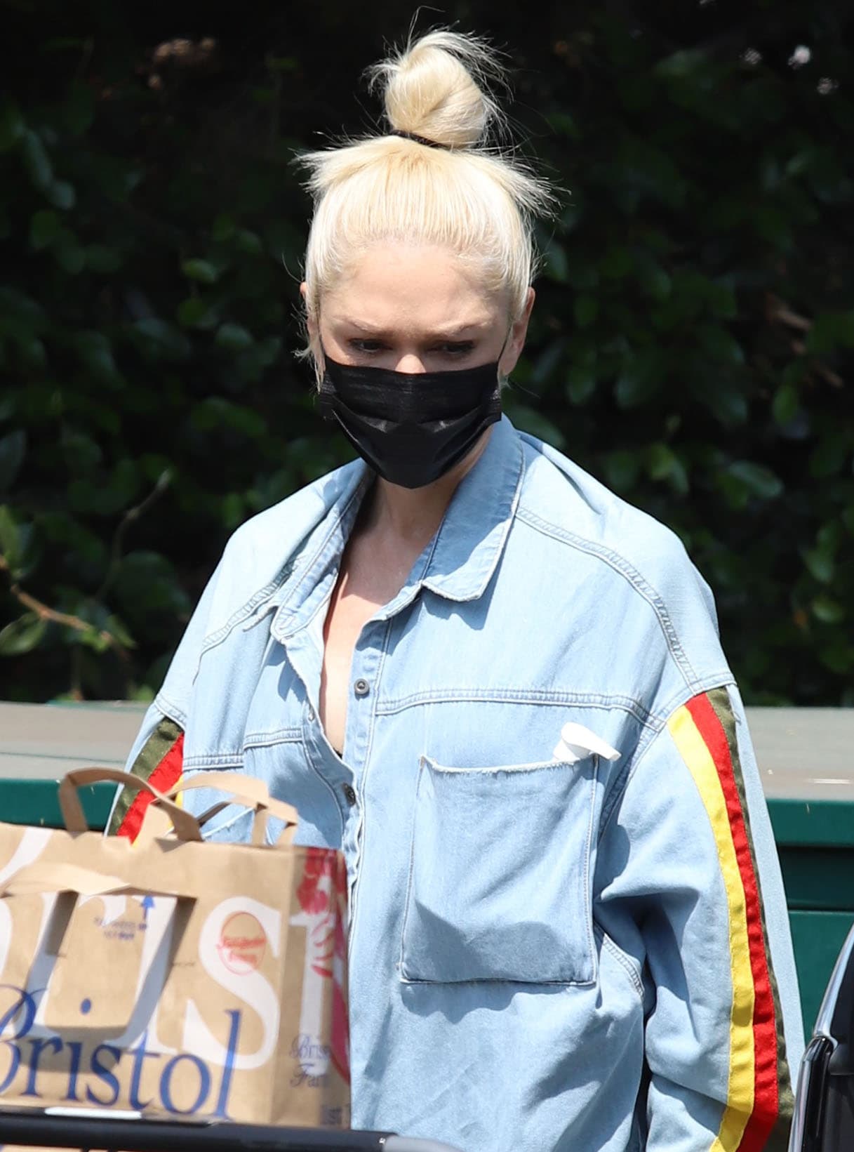 Colored racing stripes running down the sleeves add a sporty twist to Gwen Stefani’s oversized denim shirt during a grocery run in Hollywood