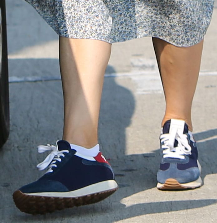 Jennifer Garner dresses down her floral midi skirt with Prada blue suede logo sneakers