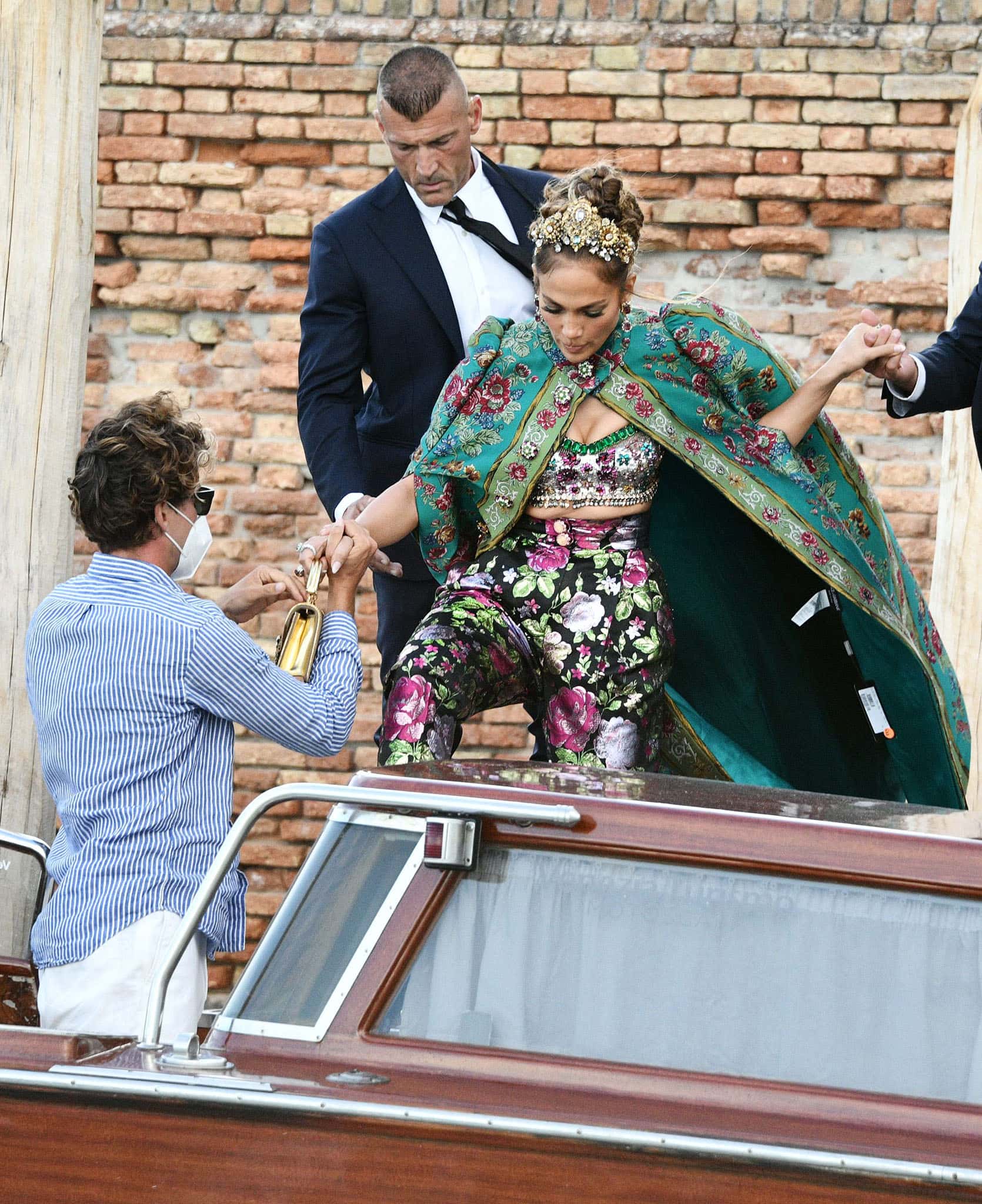 Jennifer Lopez accidentally leaves the price tag on her Dolce Gabbana pelisse cape