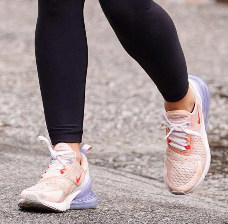 Lucy Hale adds a soft pop of color to her athleisure look with blush-pink Nike Air Max 270 sneakers featuring the model's signature oversized Air unit