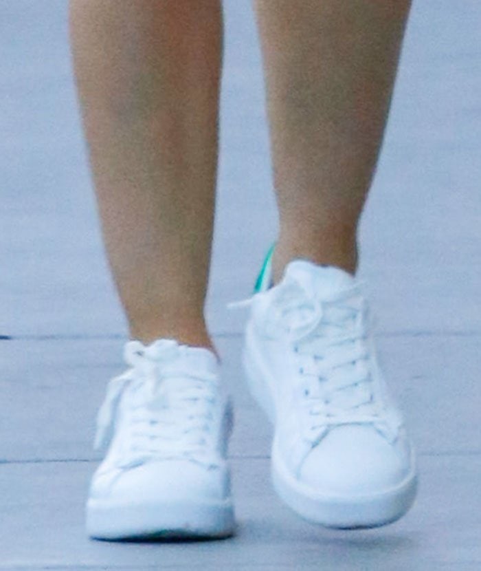Lucy Hale completes a chic and comfy casual look with white sneakers