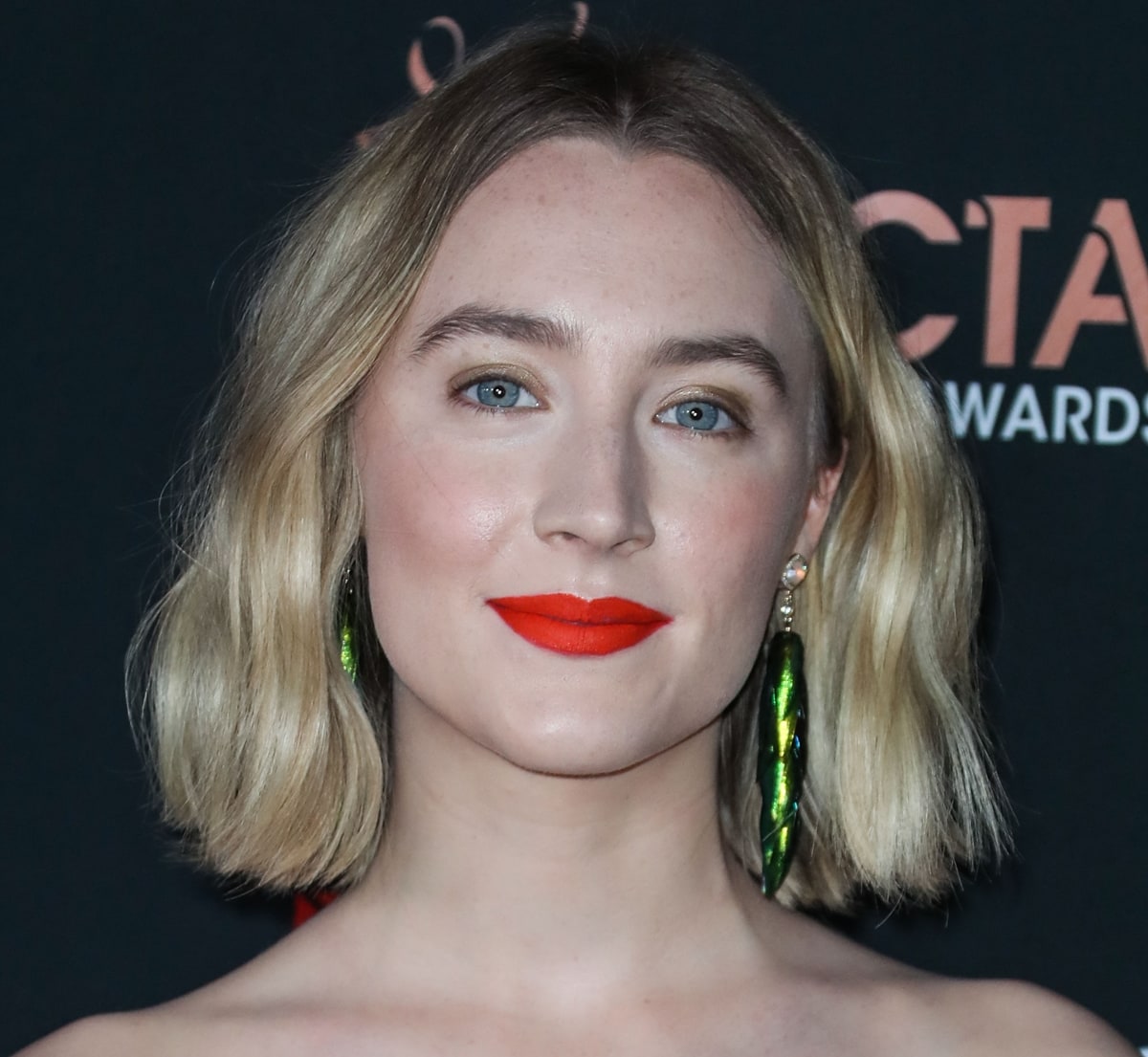 Saoirse Ronan stuns in Jacquie Aiche pave diamond opal and beetle wing earrings, adding a bold, nature-inspired touch to her elegant red carpet look