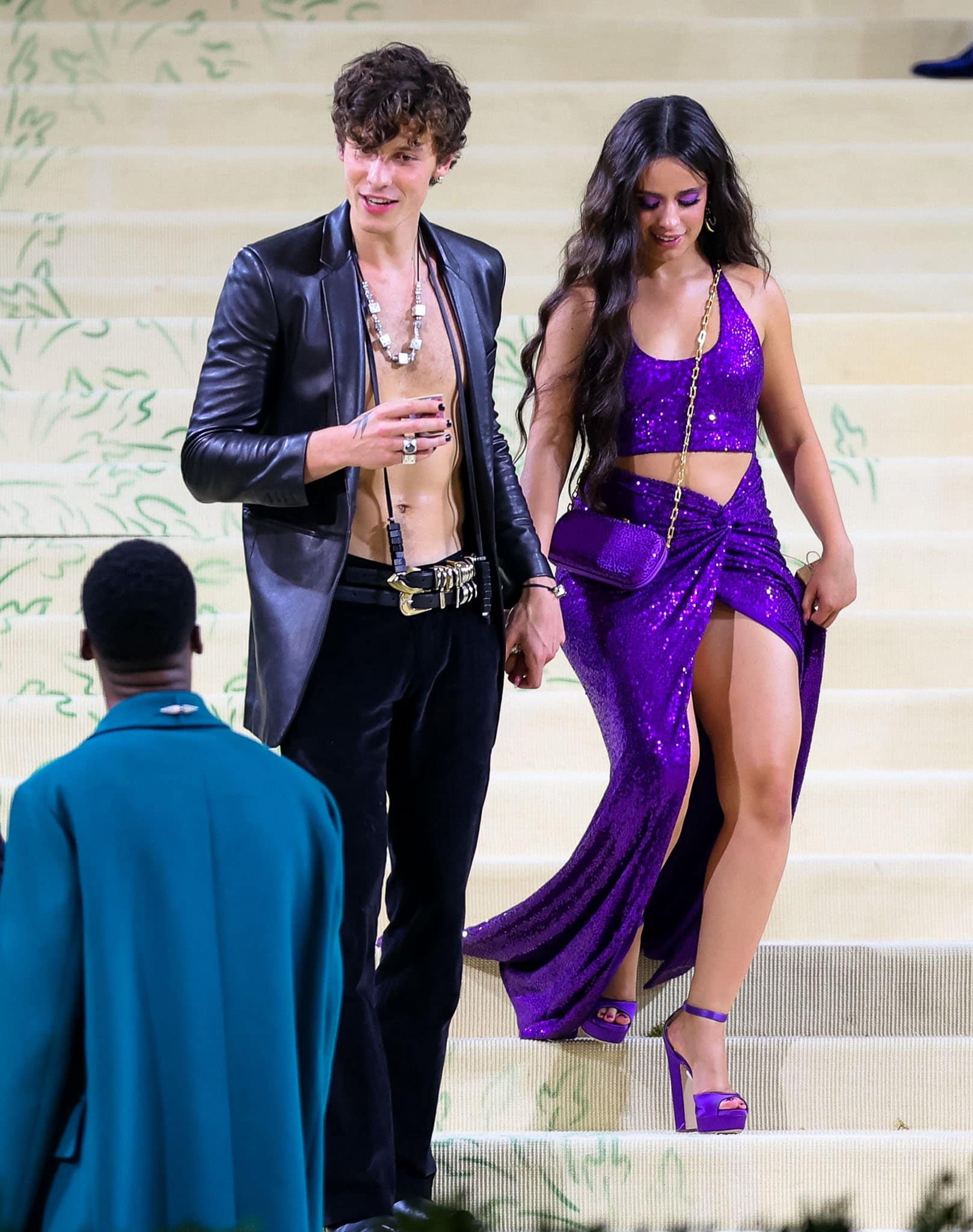 Camila Cabello turns heads in a shimmering purple Michael Kors two-piece set, styled with matching platform heels and a thigh-high slit