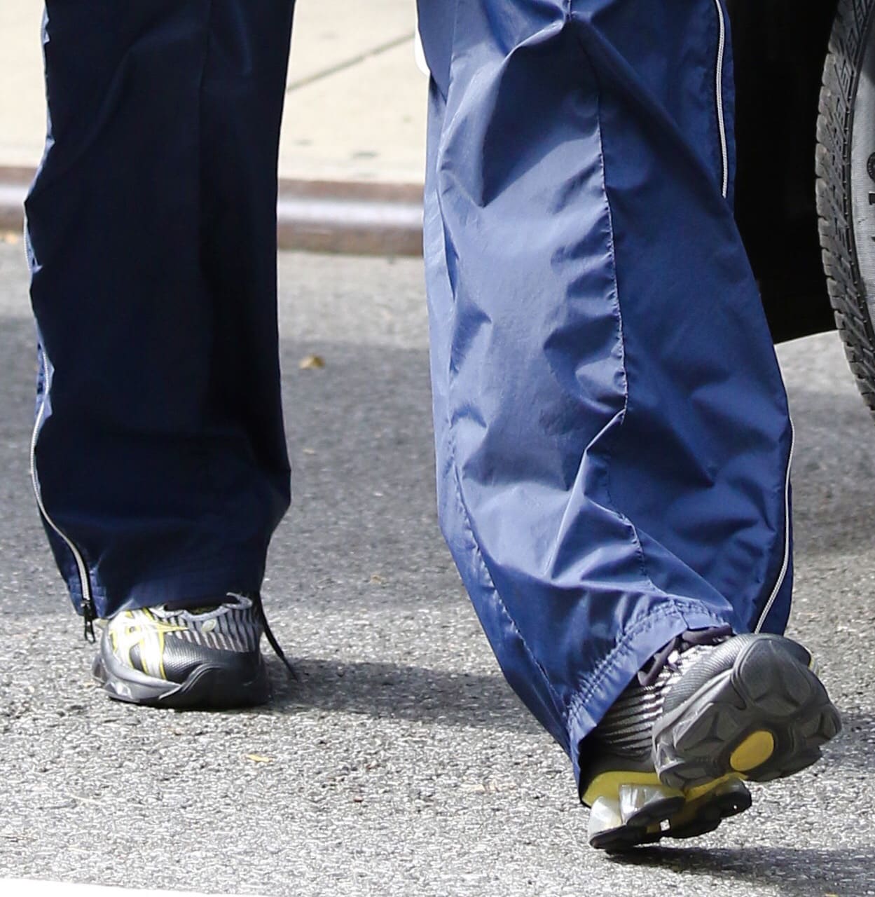 A closer look at Bella Hadid’s Kiko Kostadinov x ASICS Gel-Quantum Levitrack sneakers, with their technical layered uppers and distinctive GEL-cushioned soles visible beneath her track pants