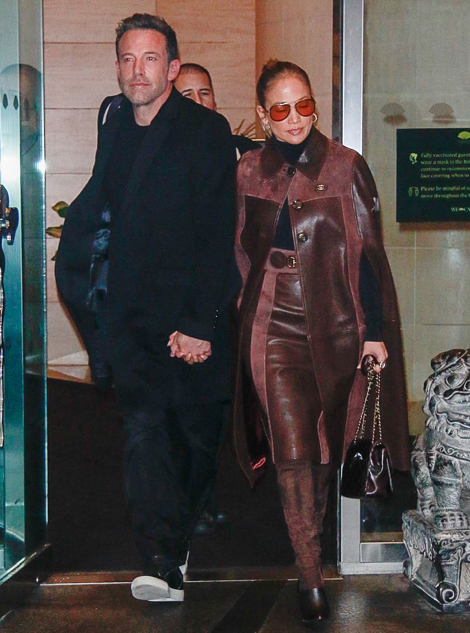 Ben Affleck and Jennifer Lopez holding hands while leaving the Mandarin Hotel in New York City