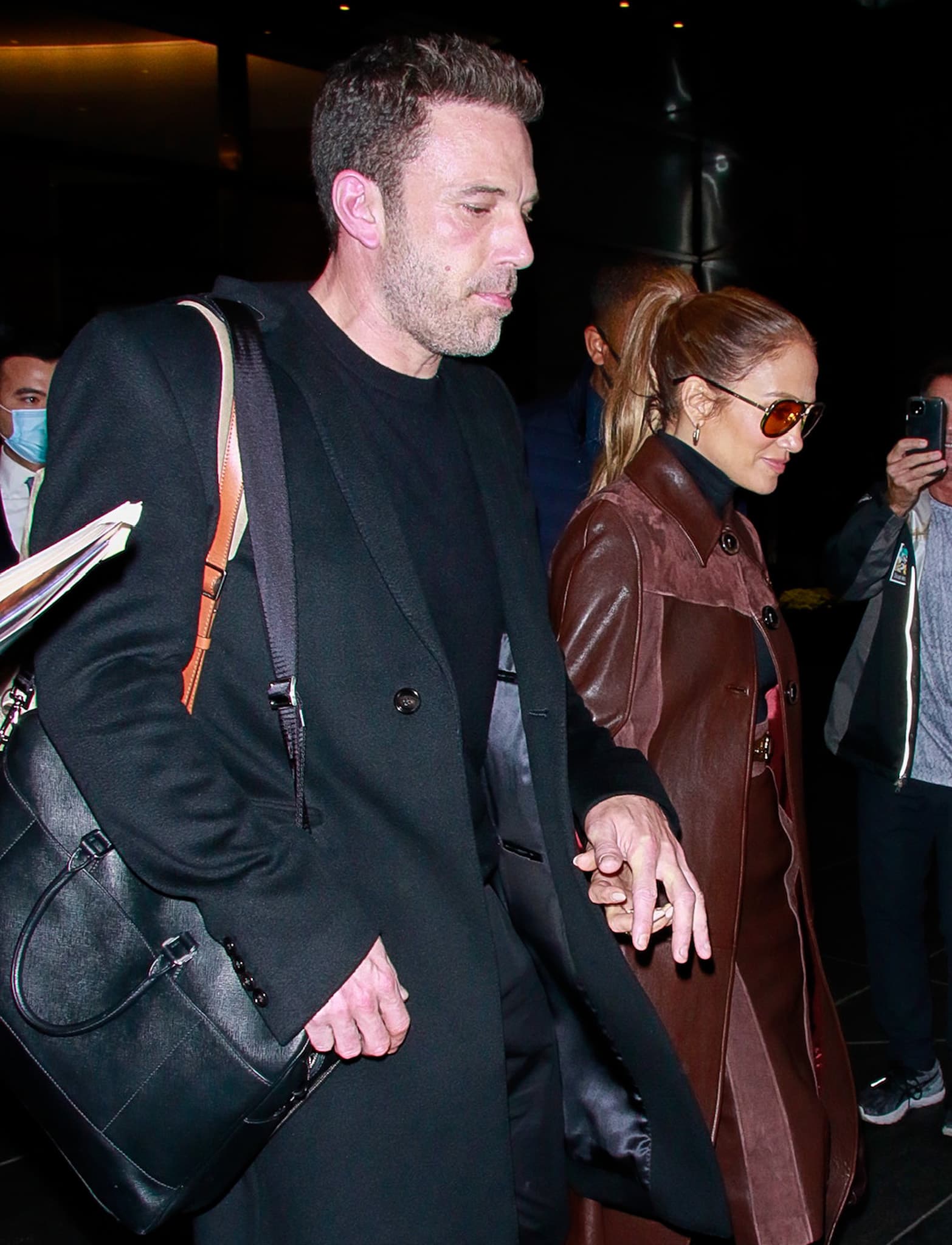 Jennifer Lopez finishes her fall outfit with Balmain "Amazon" thigh-high boots, a Chanel Classic Flap bag, and amber-tinted Isabel Marant aviators, while Ben Affleck's black leather sneakers reinforce his signature low-key style