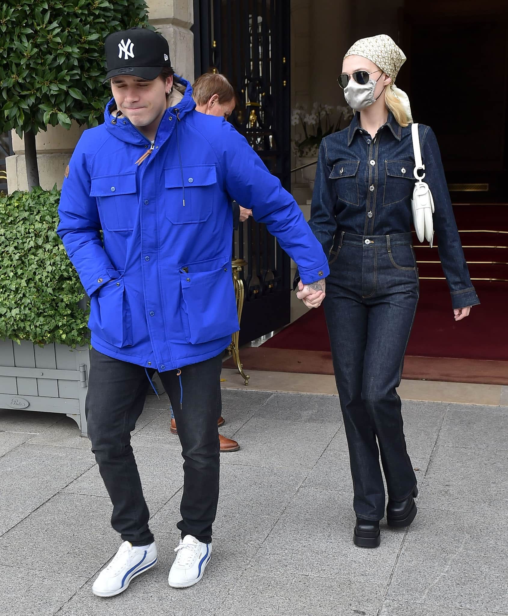 Brooklyn Beckham bundles up in a blue jacket while Nicola Peltz embraces the double denim trend as they head to a flea market
