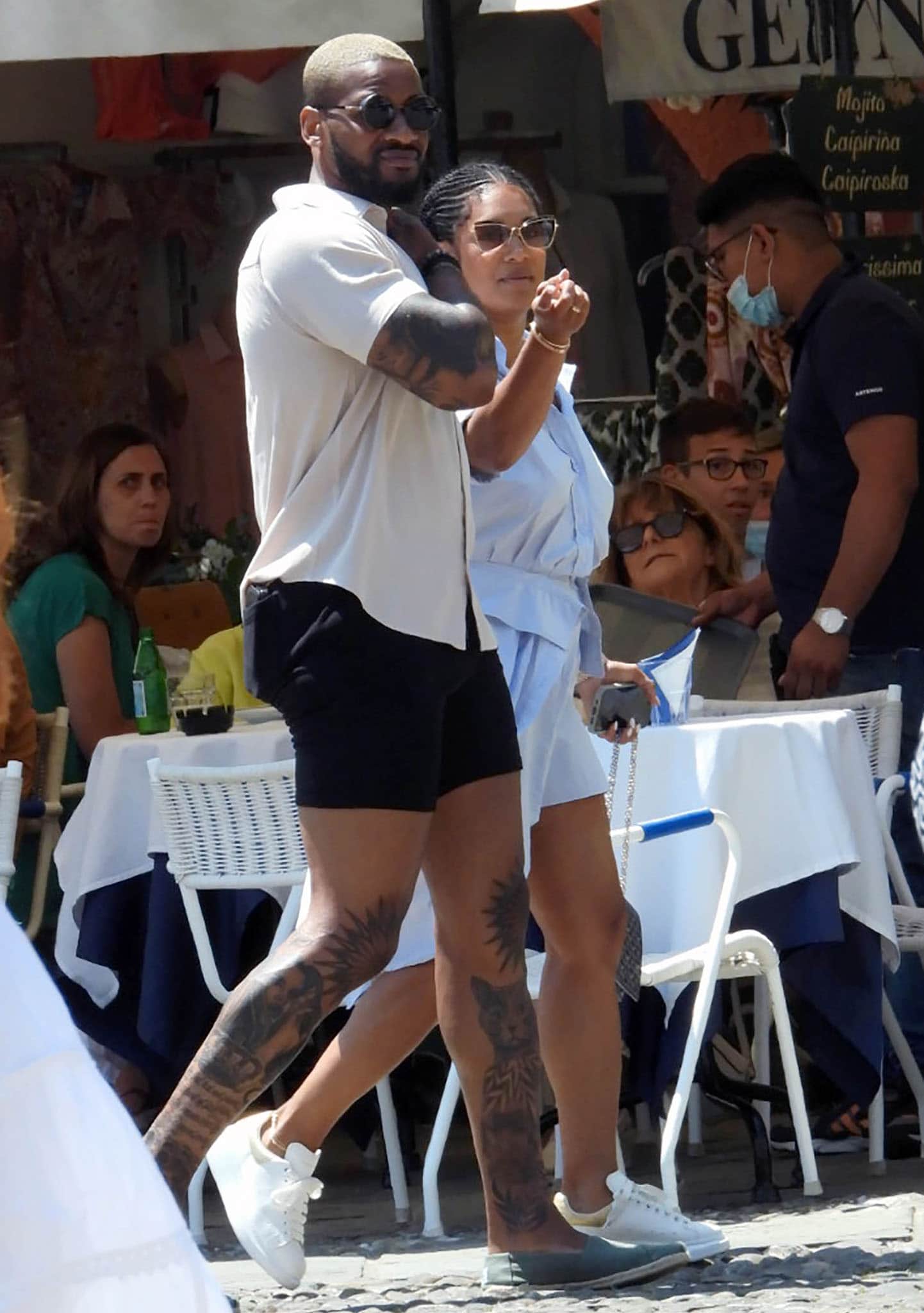 Dwyane Wade keeps it casual in white sneakers while Gabrielle Union complements him in chic slip-on flats as they stroll through Portofino, Italy, on July 11, 2021