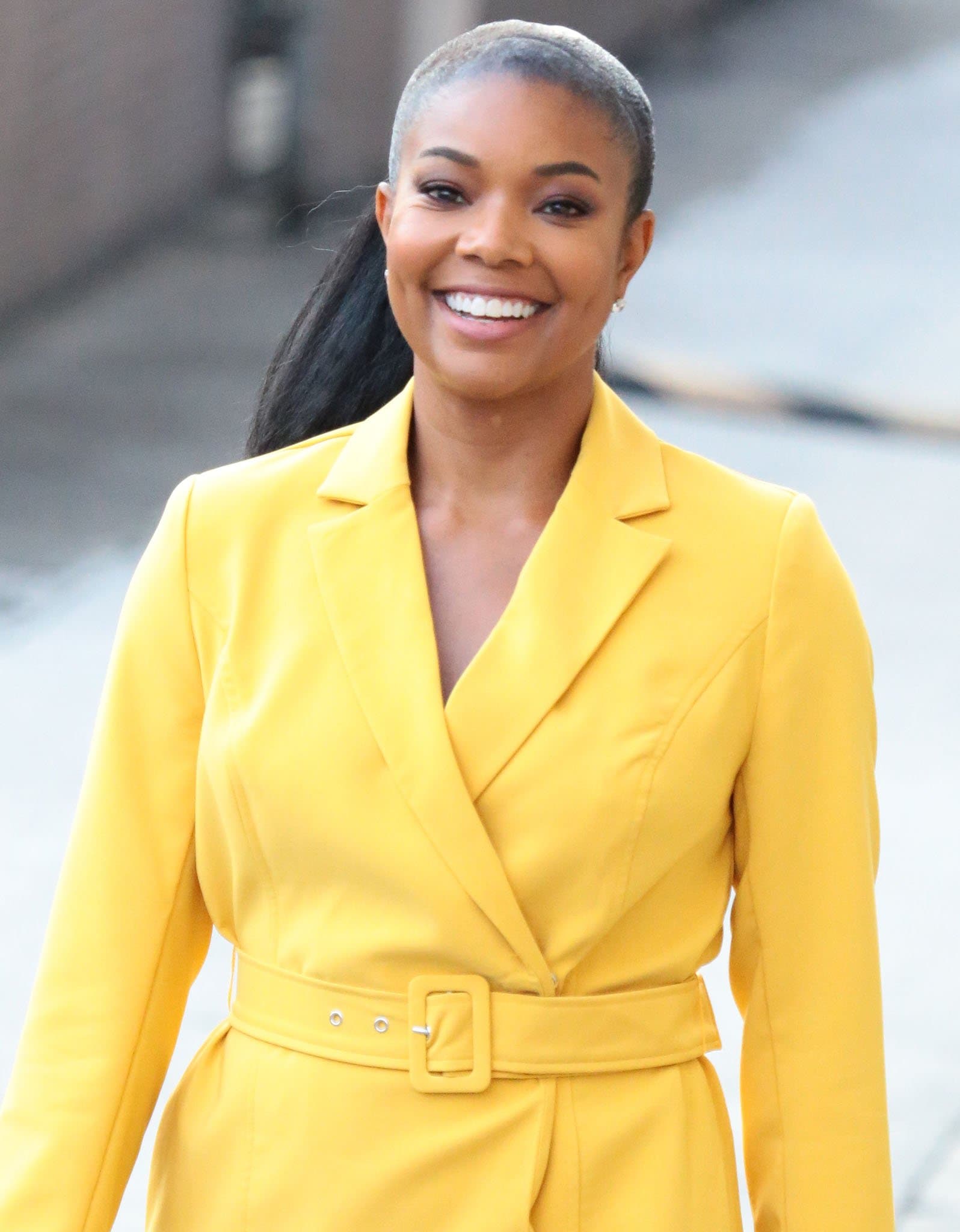 Gabrielle Union wears subtle smoky eye-makeup with nude lipstick and a high ponytail