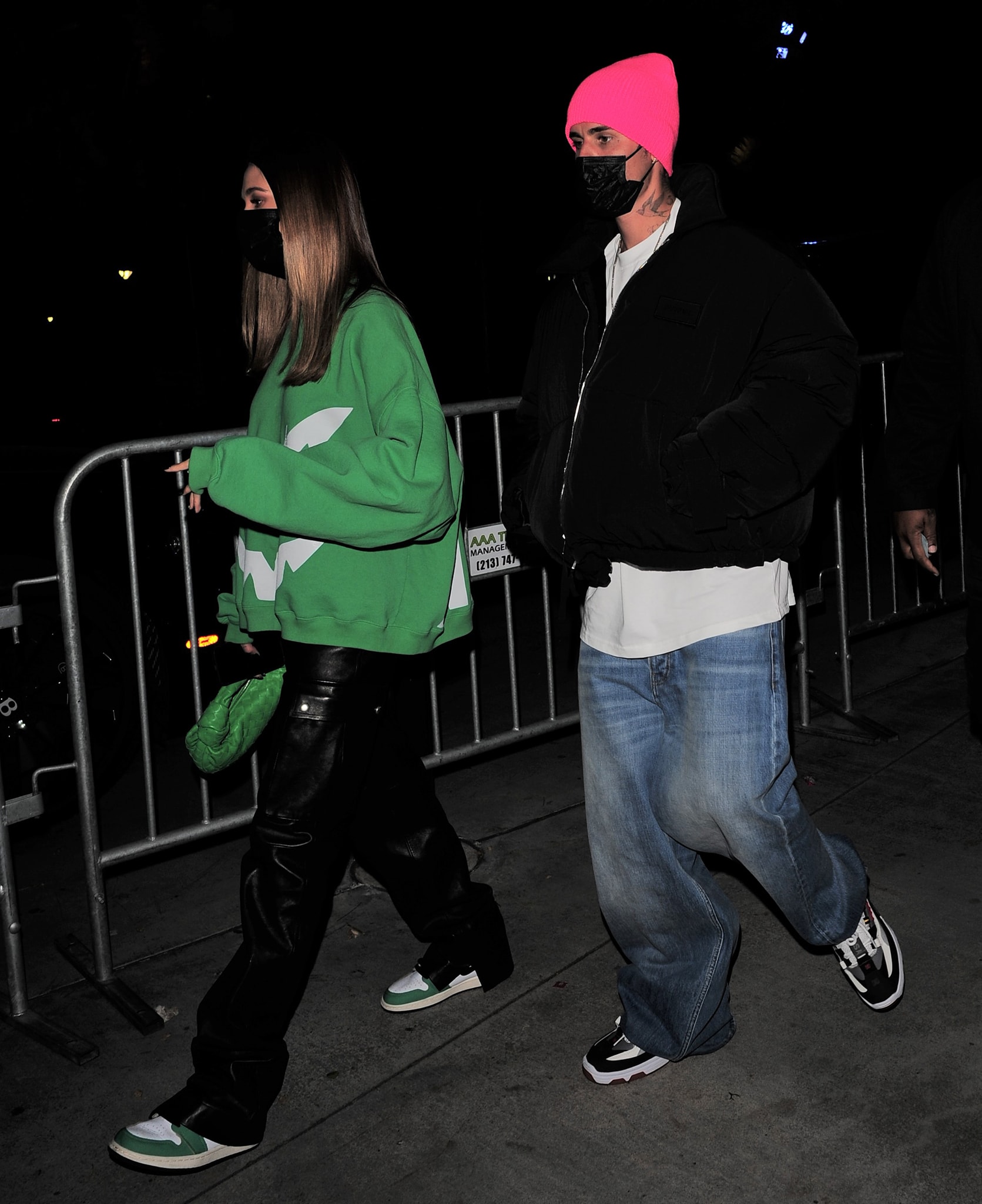 Hailey Bieber styled her Nike Air Jordan 1 Retro High OG "Lucky Green" sneakers with a green Ghost sweatshirt, slouchy Magda Butrym leather trousers, and a matching Bottega Veneta Mini Jodie bag on October 22, 2021