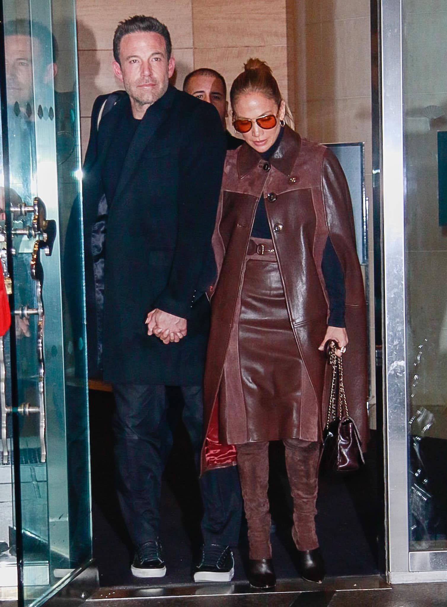 Jennifer Lopez's tonal brown styling draws the eye from her Gucci leather cape coat to her pointed-toe Balmain "Amazon" boots, creating a seamless head-to-toe autumn palette