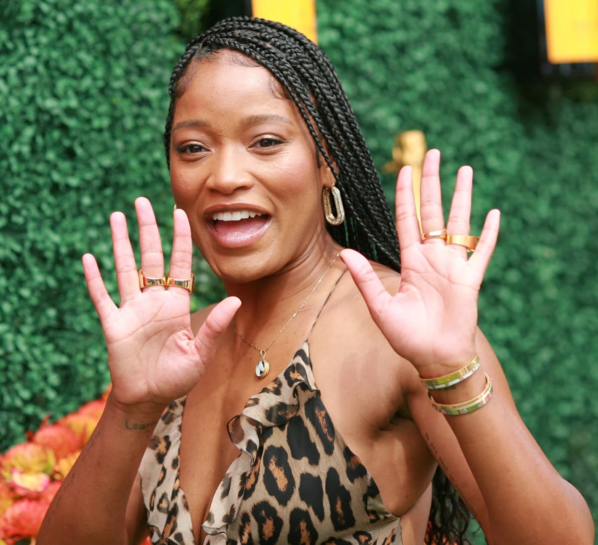 Keke Palmer flashes a smile while showing off her gold Perdifiato Jewelry accents at the 2021 Veuve Clicquot Polo Classic