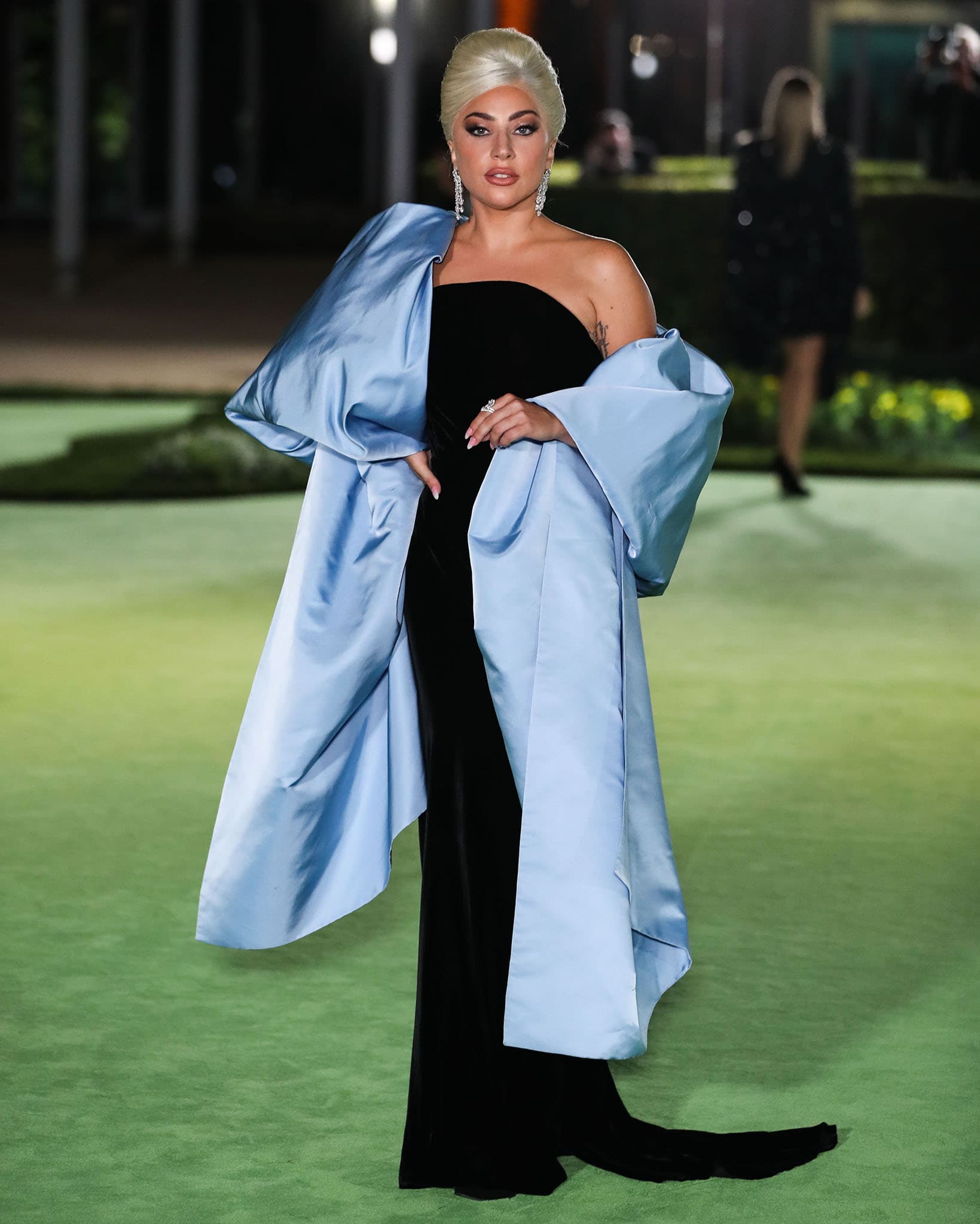 Lady Gaga channels Old Hollywood glamour in a custom Schiaparelli Haute Couture black velvet column gown with an oversized powder blue satin stole at the Academy Museum of Motion Pictures Opening Gala