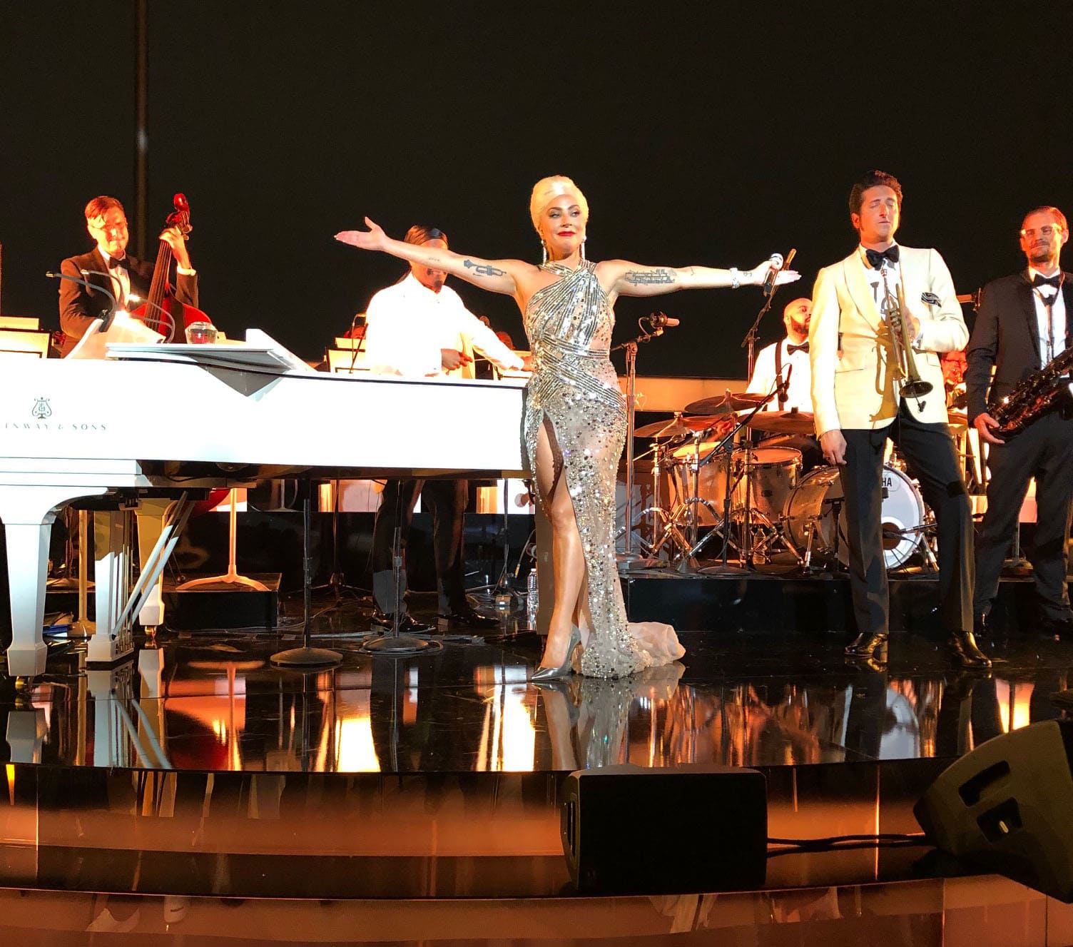Lady Gaga shifts into performance mode in a silver crystal-embellished Elie Saab Fall 2020 Couture gown, accessorized with Bulgari jewelry and metallic Jimmy Choo Anouk pumps