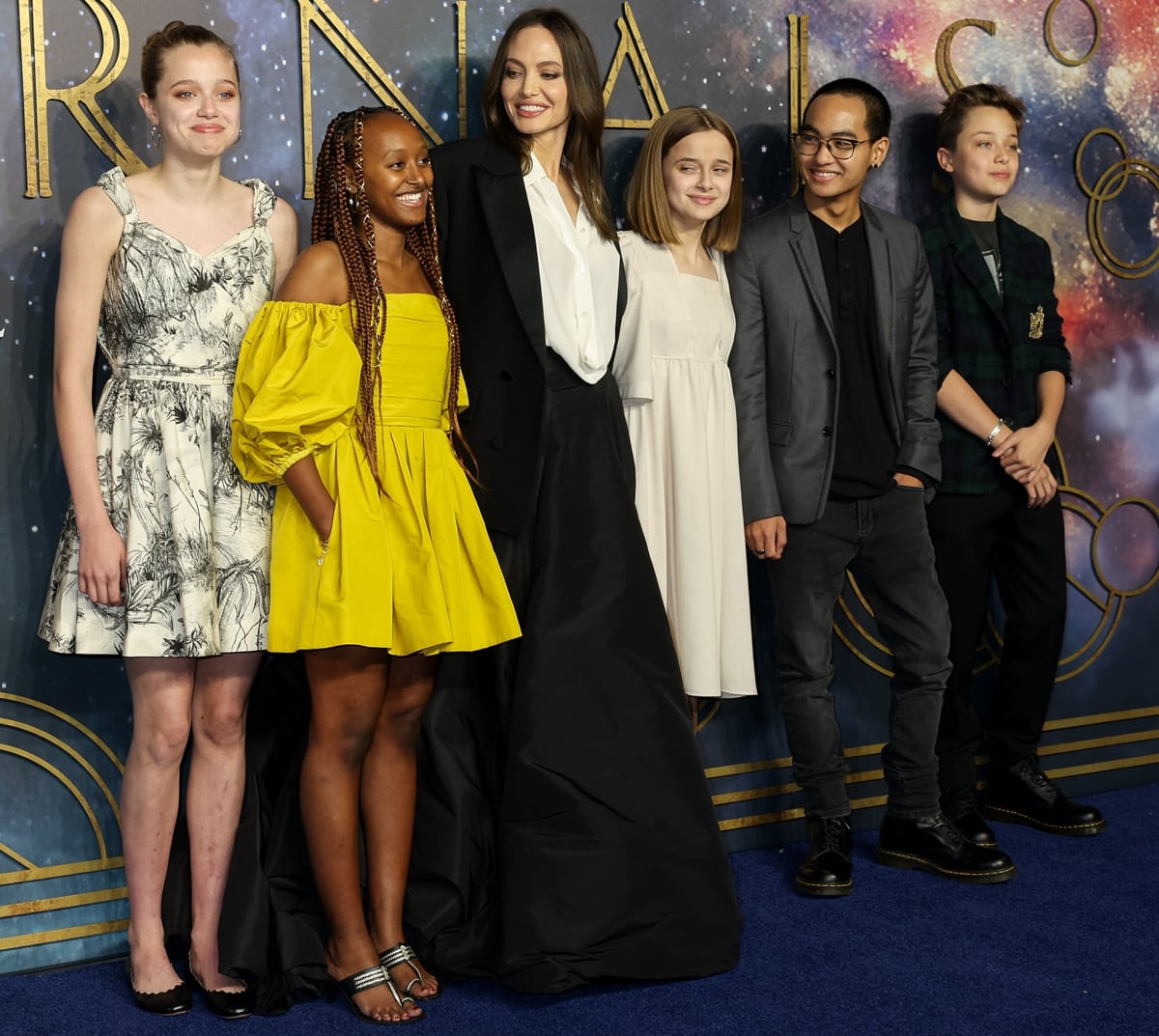 Shiloh Jolie-Pitt re-wore her mother’s black-and-white Dior dress and classic ballet flats, joining Zahara in metallic sandals, Angelina in Valentino couture, and siblings Vivienne, Maddox, and Knox Jolie-Pitt at the Eternals UK Premiere at BFI IMAX Waterloo on October 27, 2021, in London, England