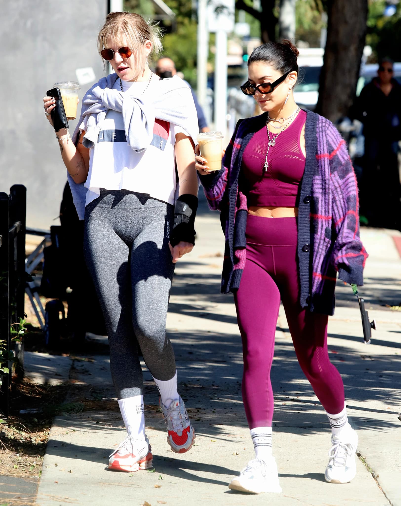 Best friends GG Magree and Vanessa Hudgens head to the Dogpound gym in Los Angeles on October 12, 2021, stepping out in contrasting sneaker styles—Magree in chunky Nike trainers and Hudgens in her go-to white Mercer Amsterdam “Jupiter” sneakers