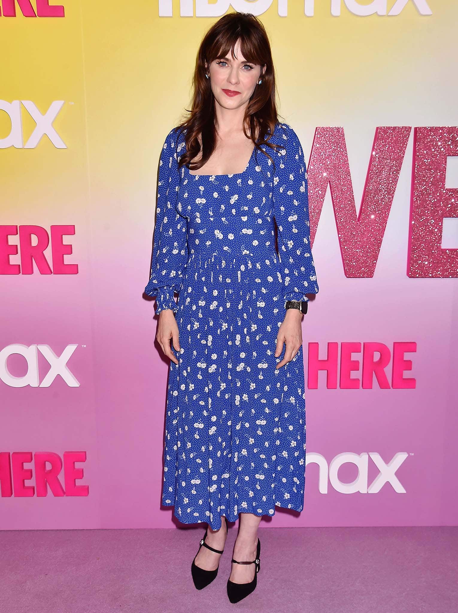Zooey Deschanel brought retro charm to the We’re Here premiere in a blue floral midi dress with puff sleeves, paired perfectly with classic black Mary Jane heels