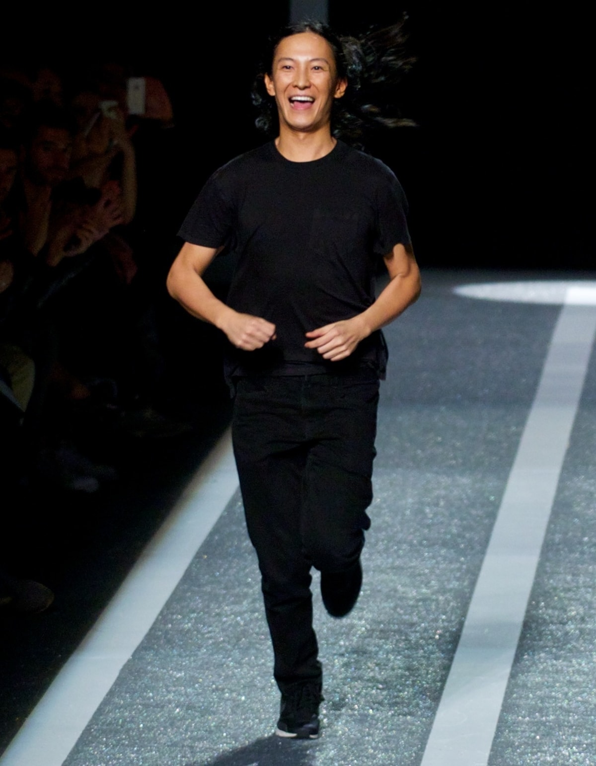 Fashion designer Alexander Wang looking excited on the runway at the Alexander Wang x HM Collection Launch