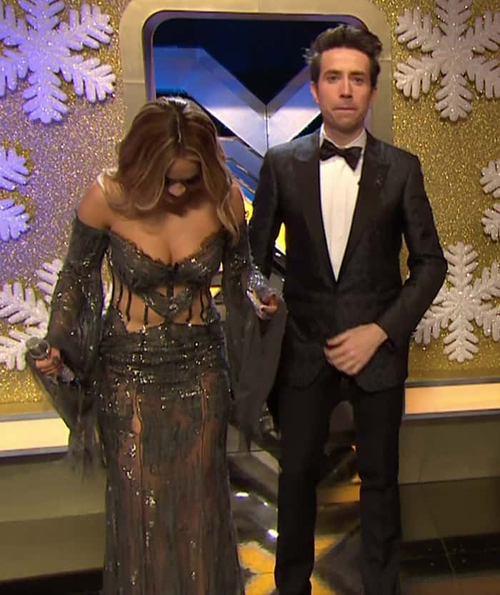 Rita Ora suffers a wardrobe mishap as her sheer embellished gown tears mid-broadcast on The Xtra Factor, but she handles the fashion emergency with poise and a quick recovery