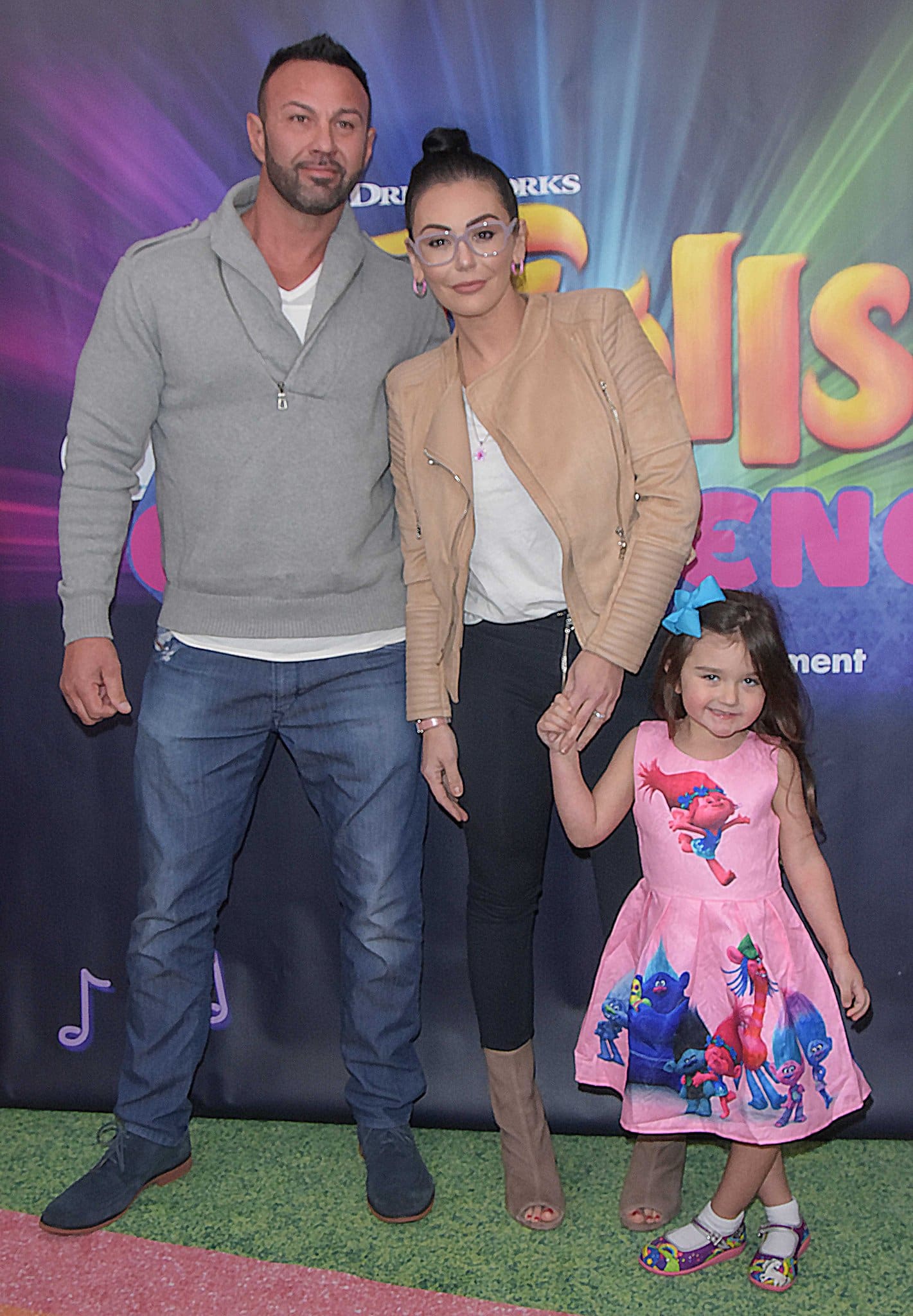 JWoww, Roger Mathews, and their daughter Meilani look adorable as they attend a family event, with JWoww dressed casually in a tan jacket and glasses, while Meilani steals the show in her cute Trolls-themed dress