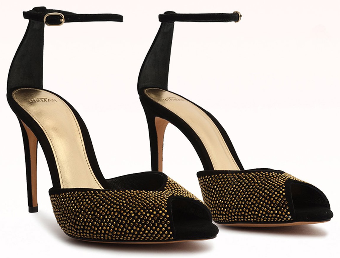 Alexandre Birman “Jenny” sandals combine black suede with dense gold-tone crystal studs, peep toes, slender ankle straps, and approximately 4-inch stiletto heels
