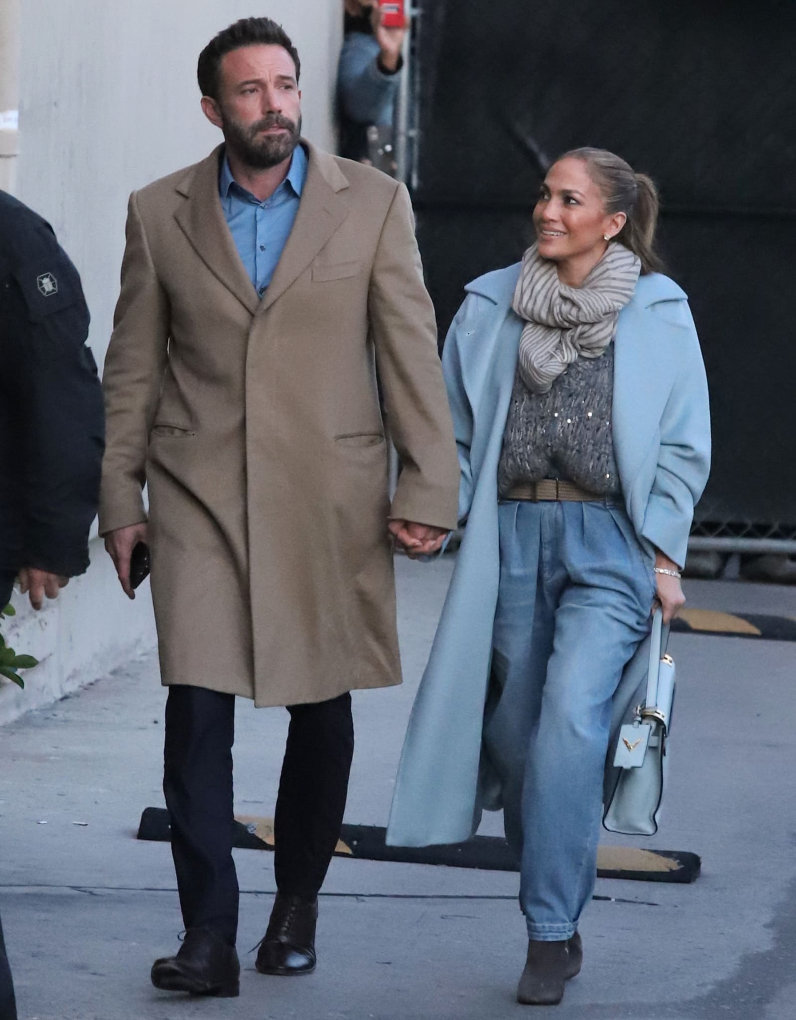 Jennifer Lopez softened her winter street style with gray suede Giuseppe Zanotti “Vera” ankle boots, pairing the sleek stiletto design with pale blue barrel-leg denim, a chunky Brunello Cucinelli knit, and a powder-blue Max Mara coat as she walked hand in hand with Ben Affleck outside Jimmy Kimmel Live! in Los Angeles on December 15, 2021