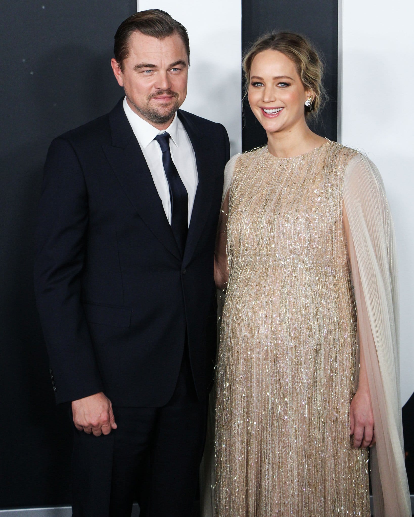 Leonardo DiCaprio poses alongside co-star Jennifer Lawrence in a sustainable navy suit