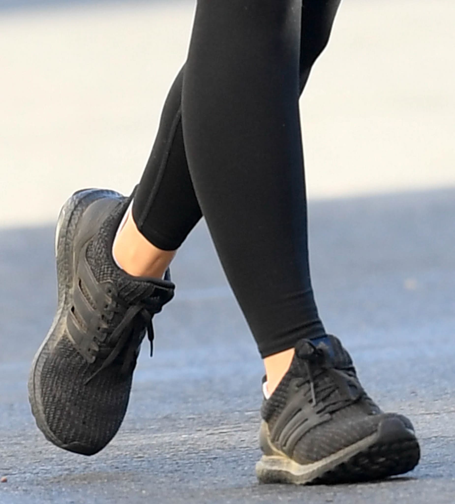 A closer look at Olivia Wilde’s black Adidas Ultraboost 4.0 DNA sneakers, known for their sock-like Primeknit fit and cushioned Boost sole