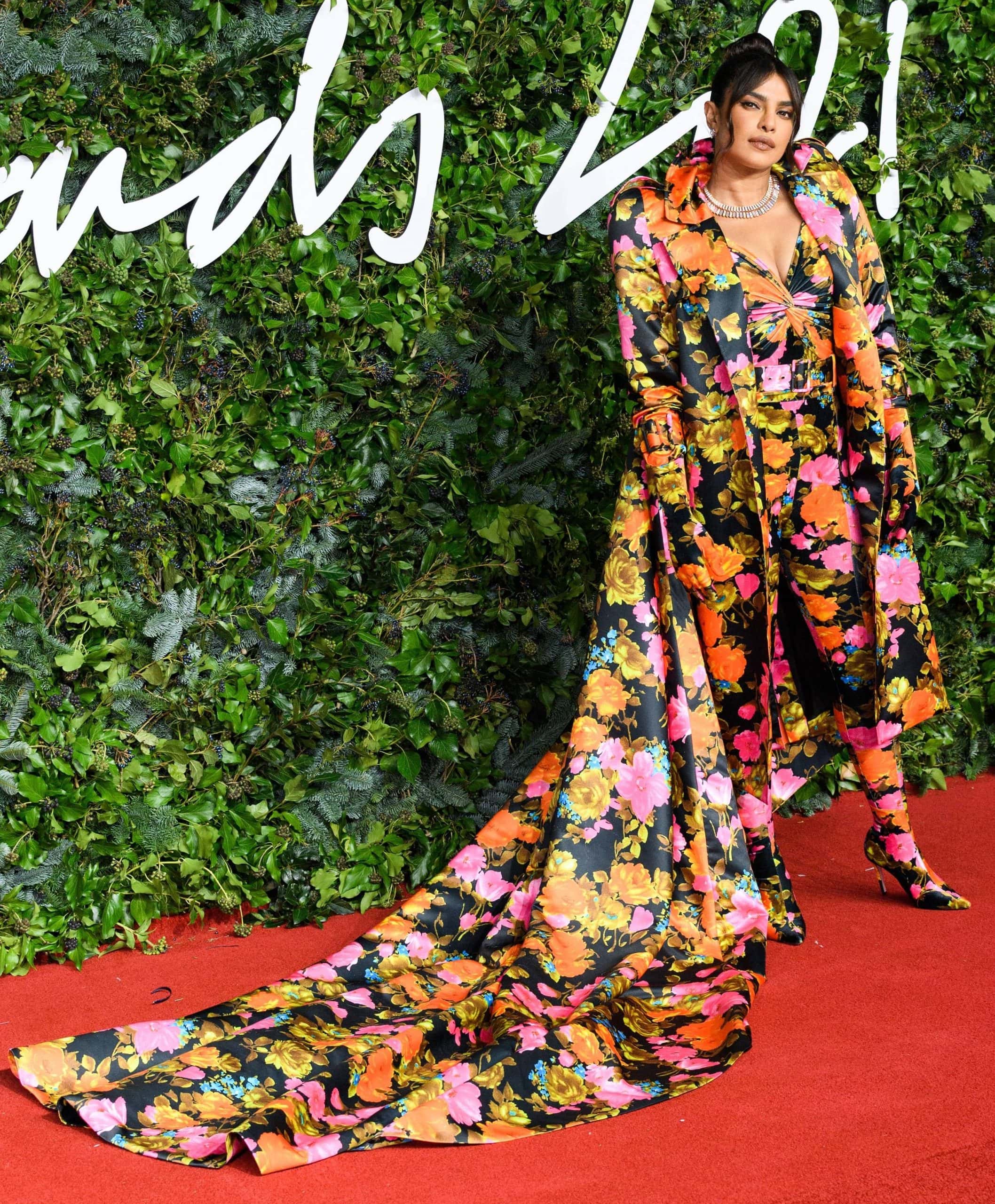 The matching floral-print Richard Quinn boots blend seamlessly into Priyanka Chopra's catsuit and sweeping opera coat, creating an uninterrupted silhouette from head to toe