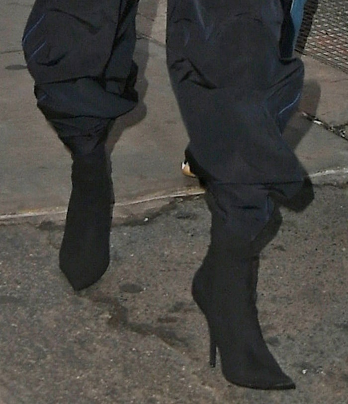 Rihanna elevated her ensemble with sleek Balenciaga Knife Crepe Jersey Boots, known for their sharp pointed toes and slender stiletto heels
