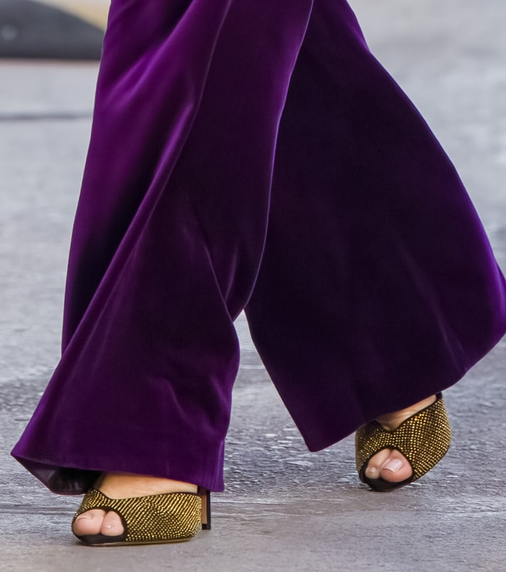 Alexandre Birman’s “Jenny” sandals bring contrast to Bullock’s monochromatic suit with gold-tone crystal studs, open toes, and slim stiletto heels