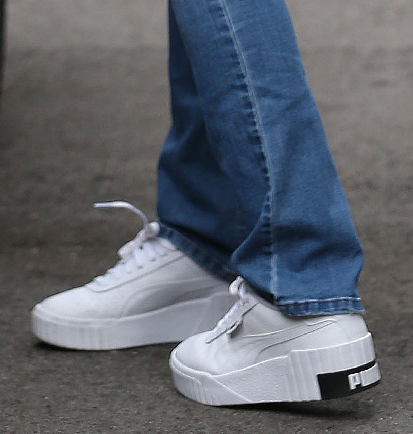 A closer look at Sofia Vergara’s white Puma Cali Wedge sneakers reveals the elevated sole, ribbed heel, and contrasting black Puma branding at the back