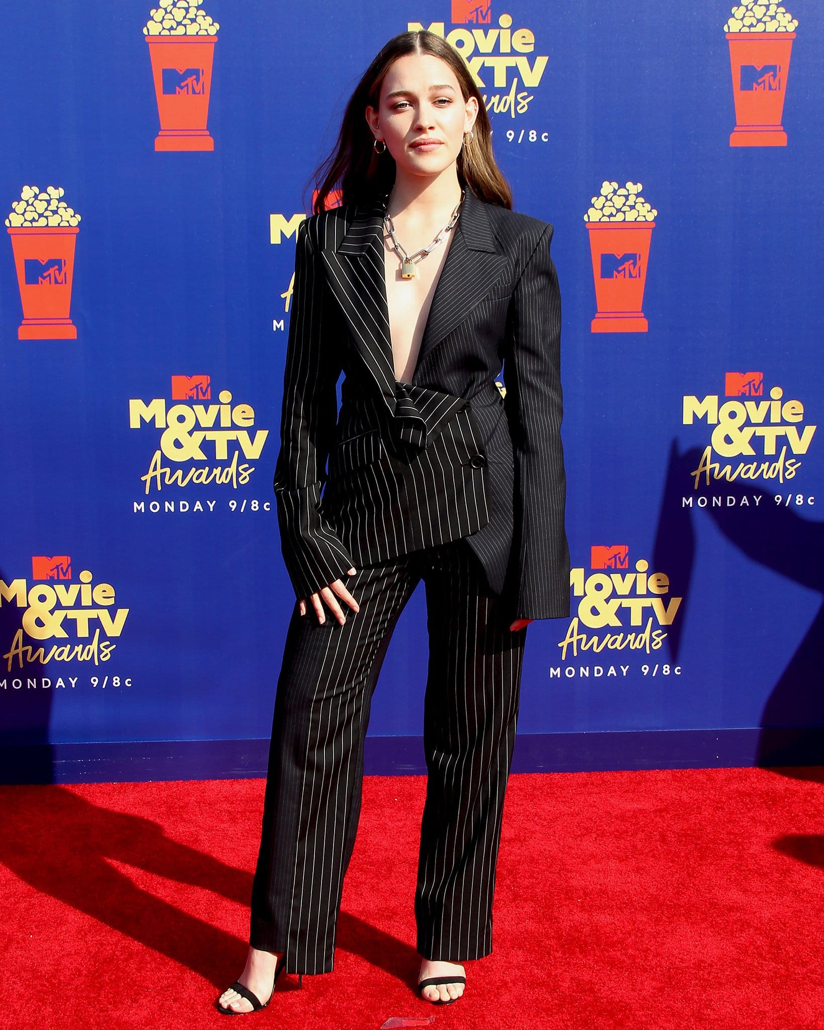 Victoria Pedretti commands attention at the MTV Movie TV Awards, wearing a sleek pinstriped suit paired with minimalist heels and bold accessories