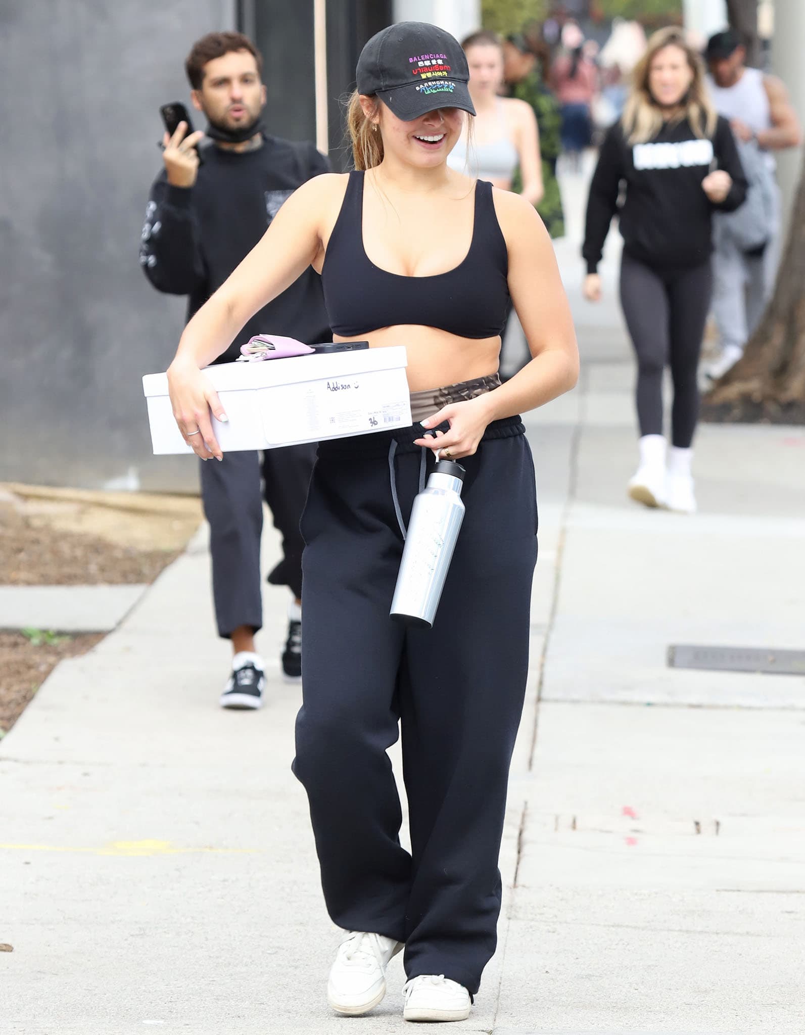Addison Rae steps out of Dogpound gym in West Hollywood on January 17, 2022, finishing her relaxed athleisure look with classic white Reebok Club C sneakers for an effortless off-duty vibe