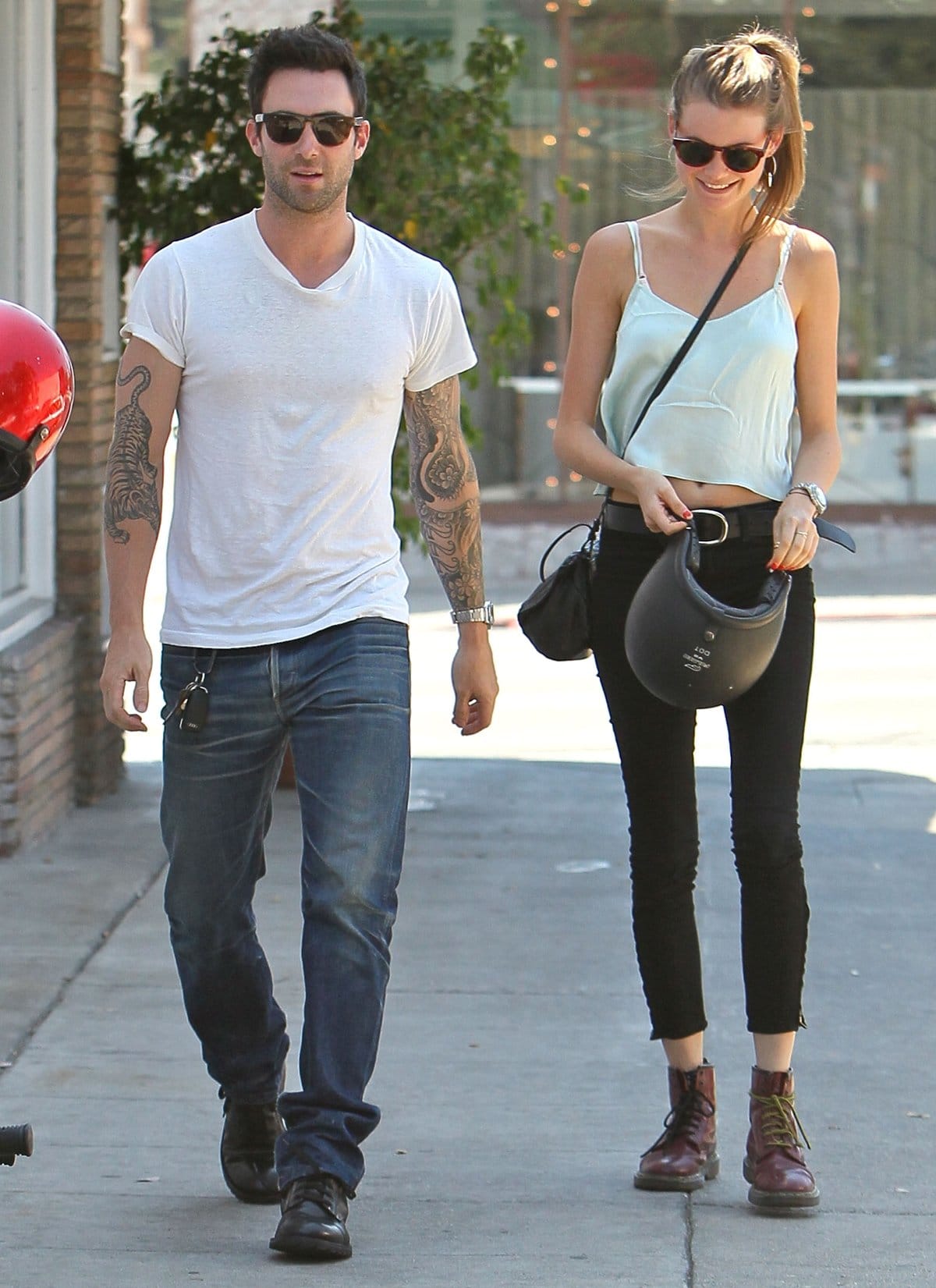 Adam Levine and Behati Prinsloo keep it cool and casual while out and about, with Adam in a laid-back white tee and jeans, and Behati sporting a cropped top and classic Dr. Martens boots