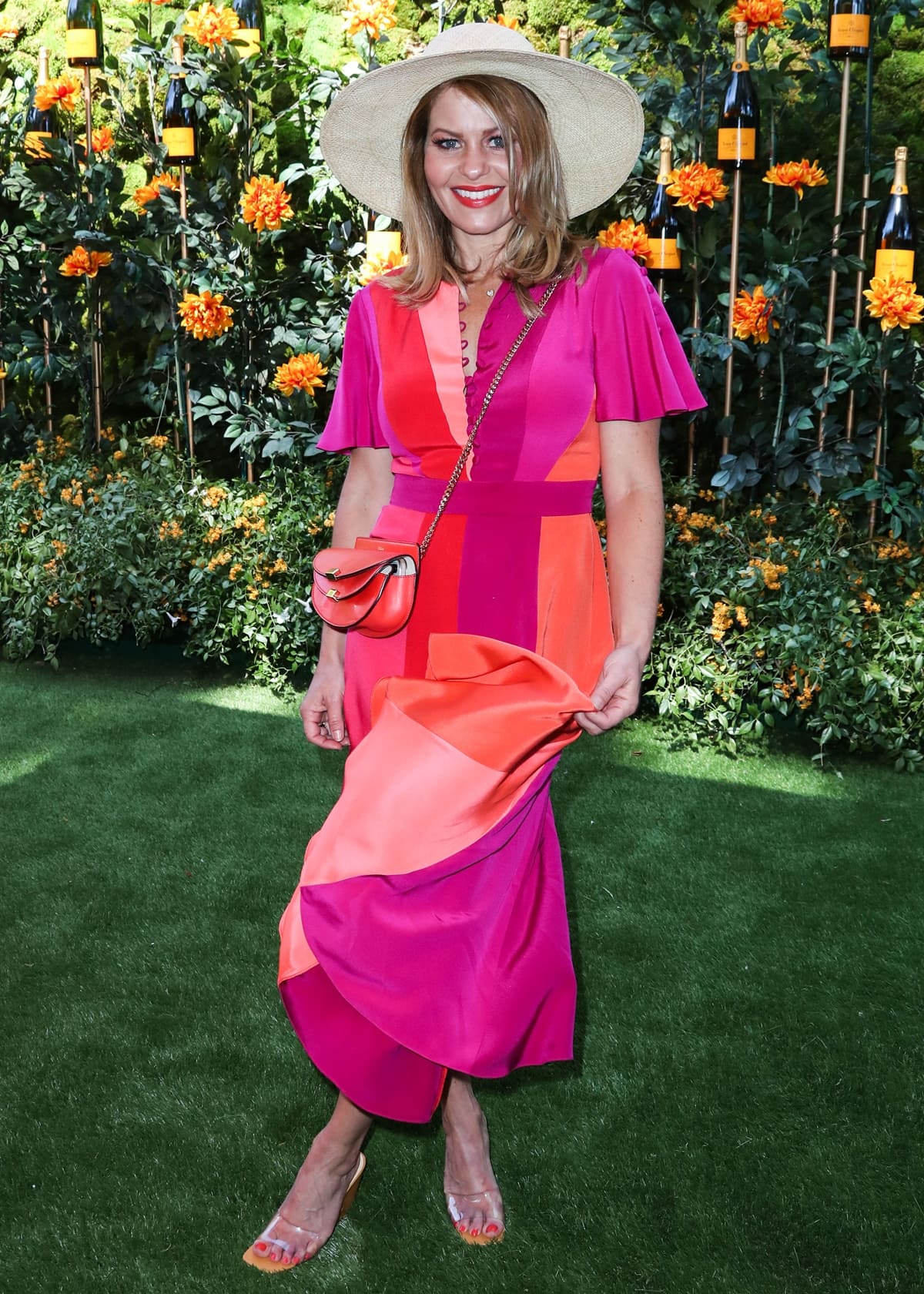 Candace Cameron Bure brightened the event in a vibrant color-block Prabal Gurung dress paired with clear PVC heels and a wide-brim straw hat at the 10th Annual Veuve Clicquot Polo Classic Los Angeles, held at Will Rogers State Historic Park on October 5, 2019, in Pacific Palisades, California